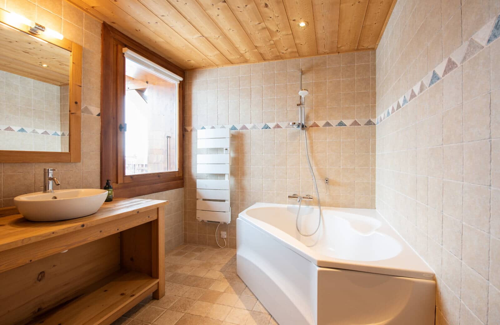 Bathroom with corner soaking tub and heated towel rail