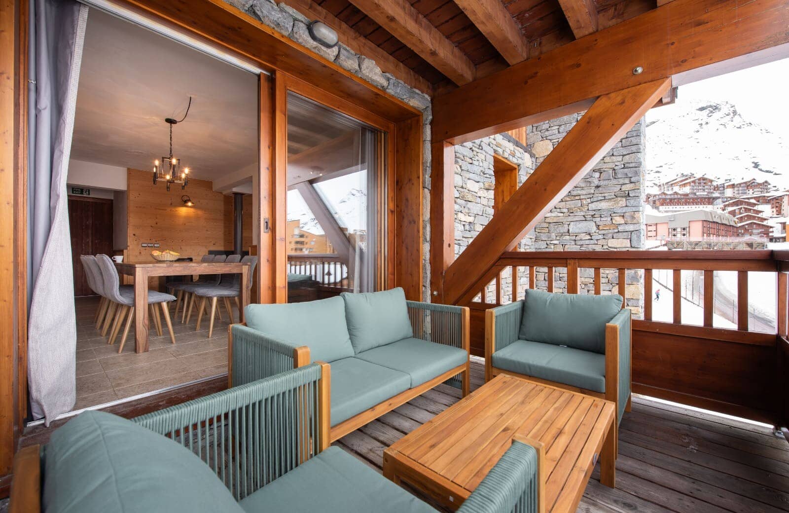 Covered balcony with lounge seating and views of the ski village