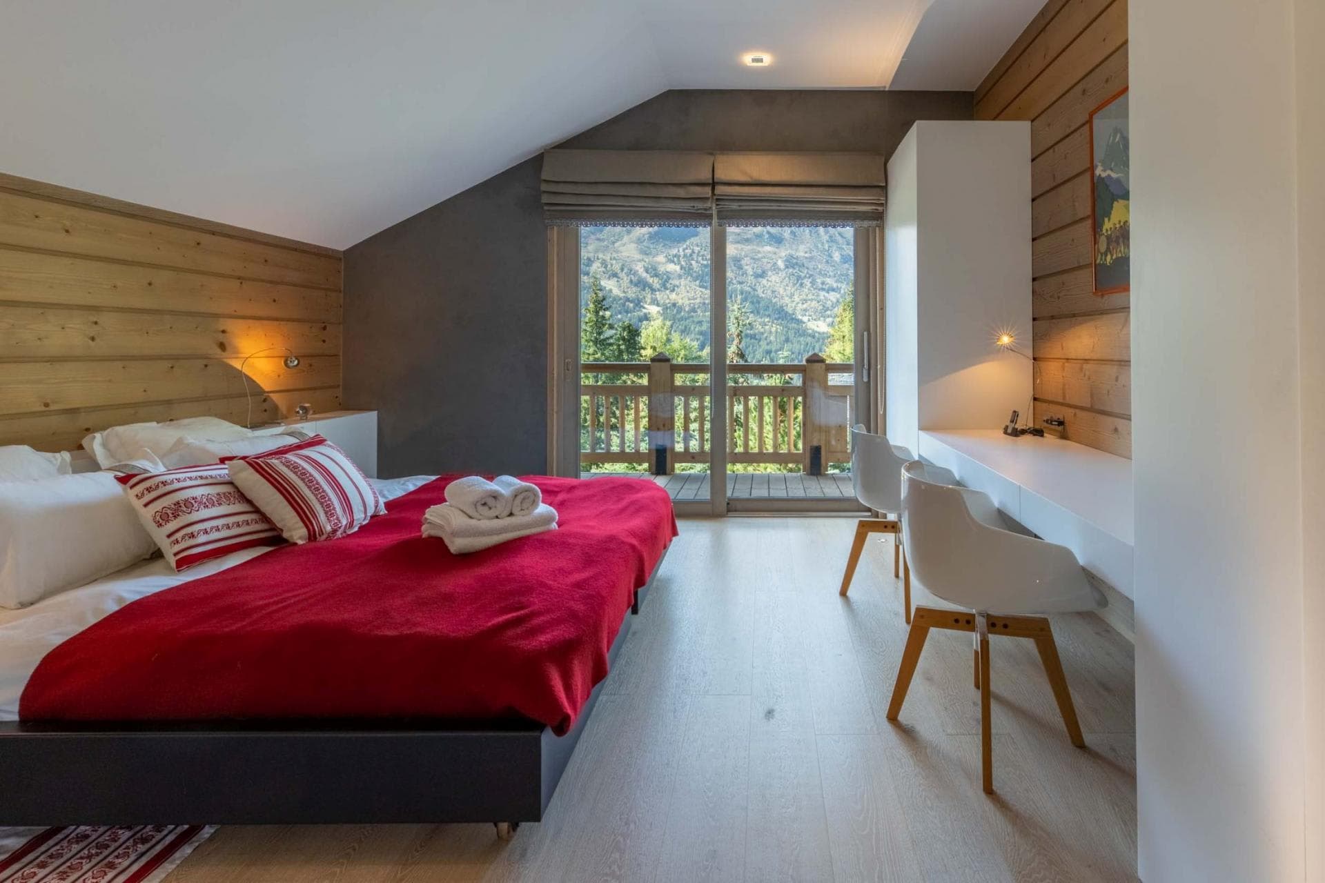 Bedroom with king bed, mountain view balcony, and dual workspace