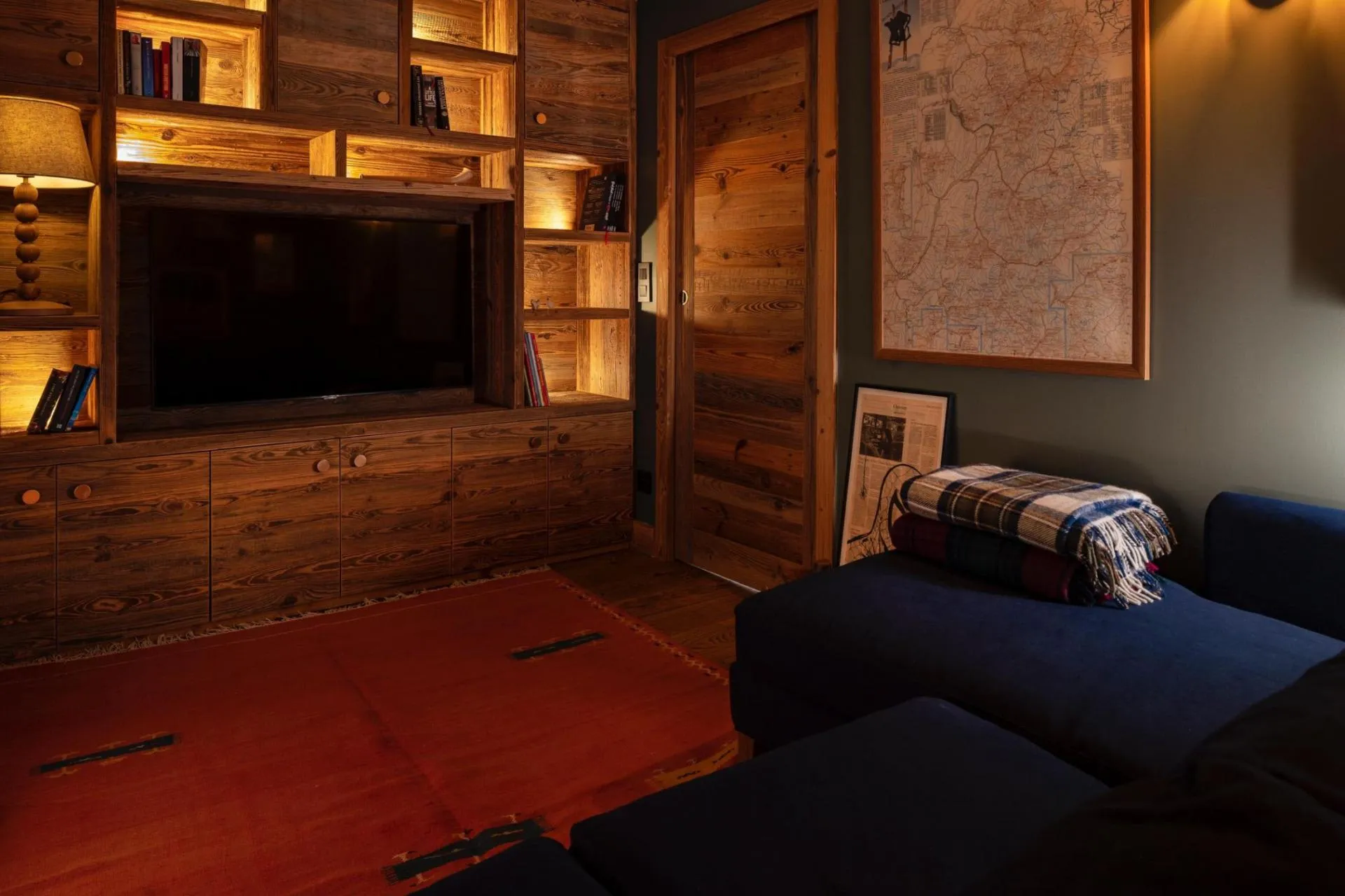 TV lounge with sofa seating and bookshelves