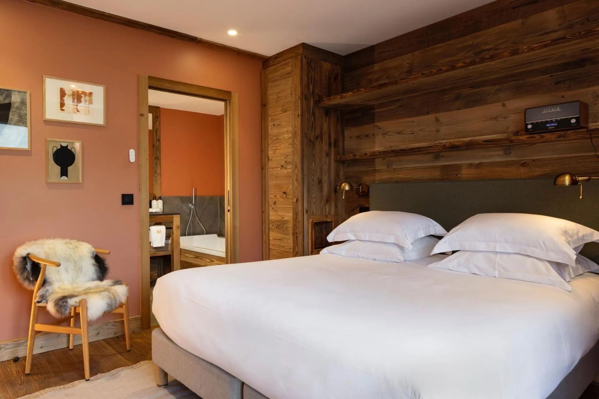 Double bedroom with timber walls and television