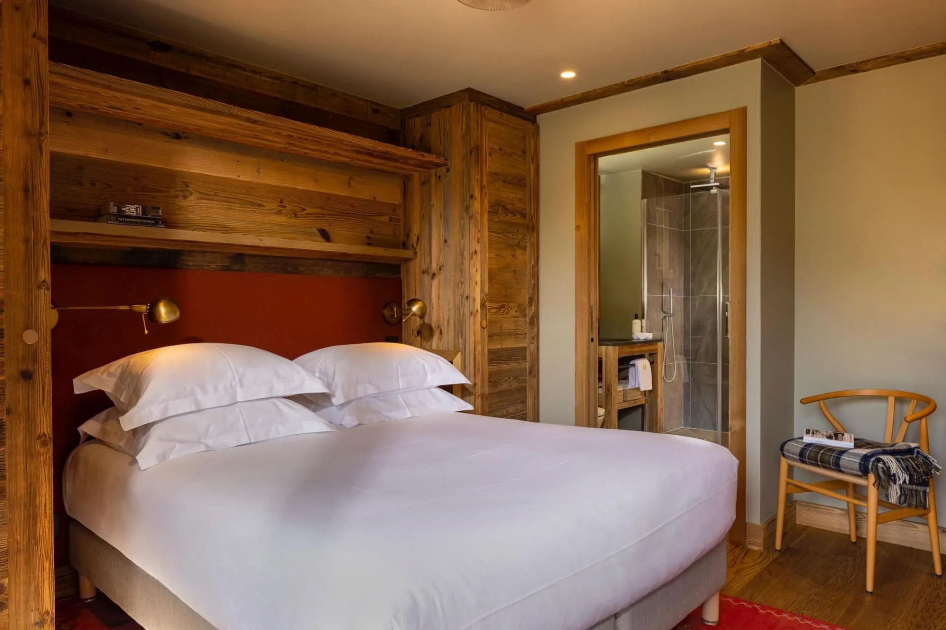 Double bedroom with timber walls and adjoining bathroom