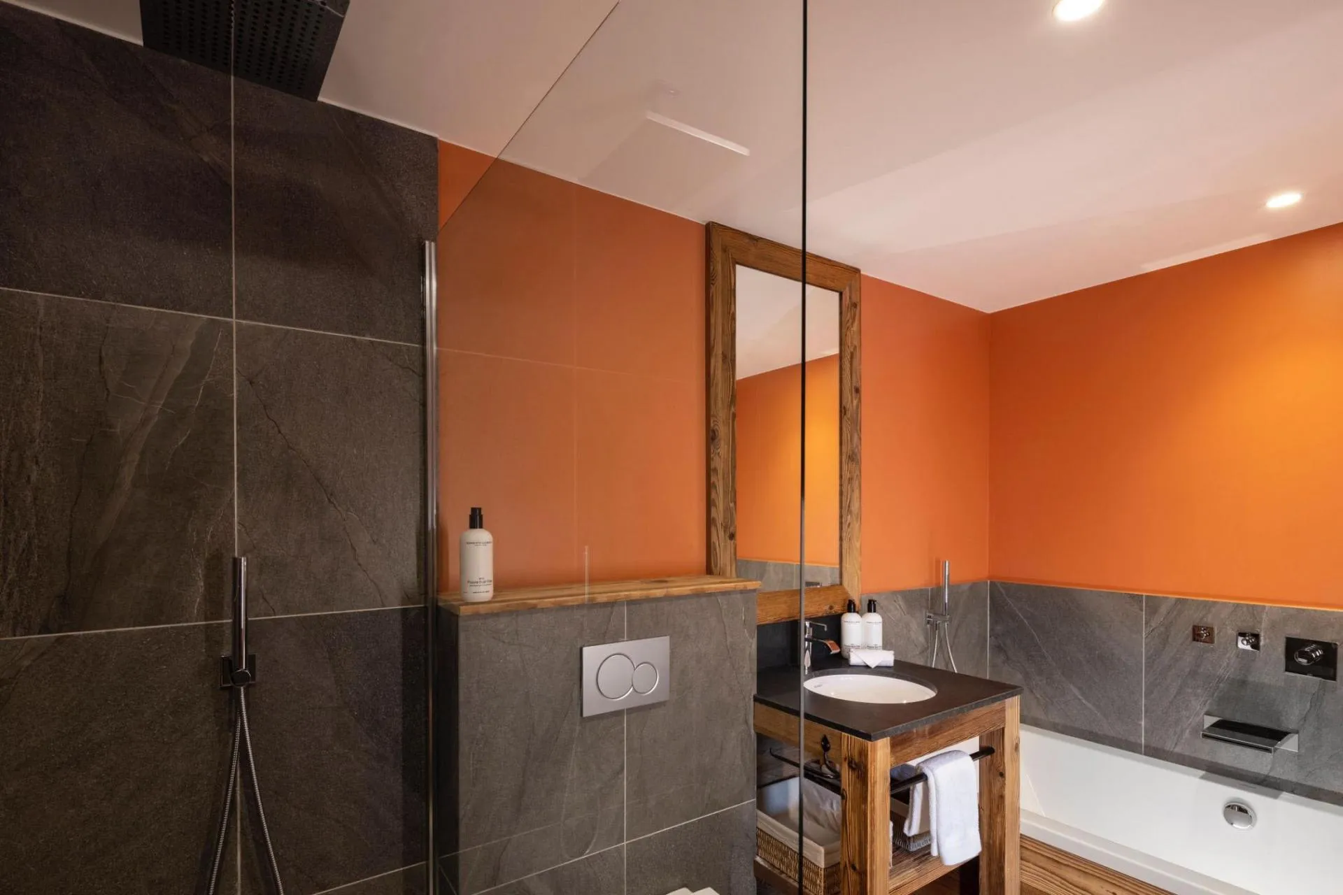 Bathroom with bathtub, tiled shower area and basin