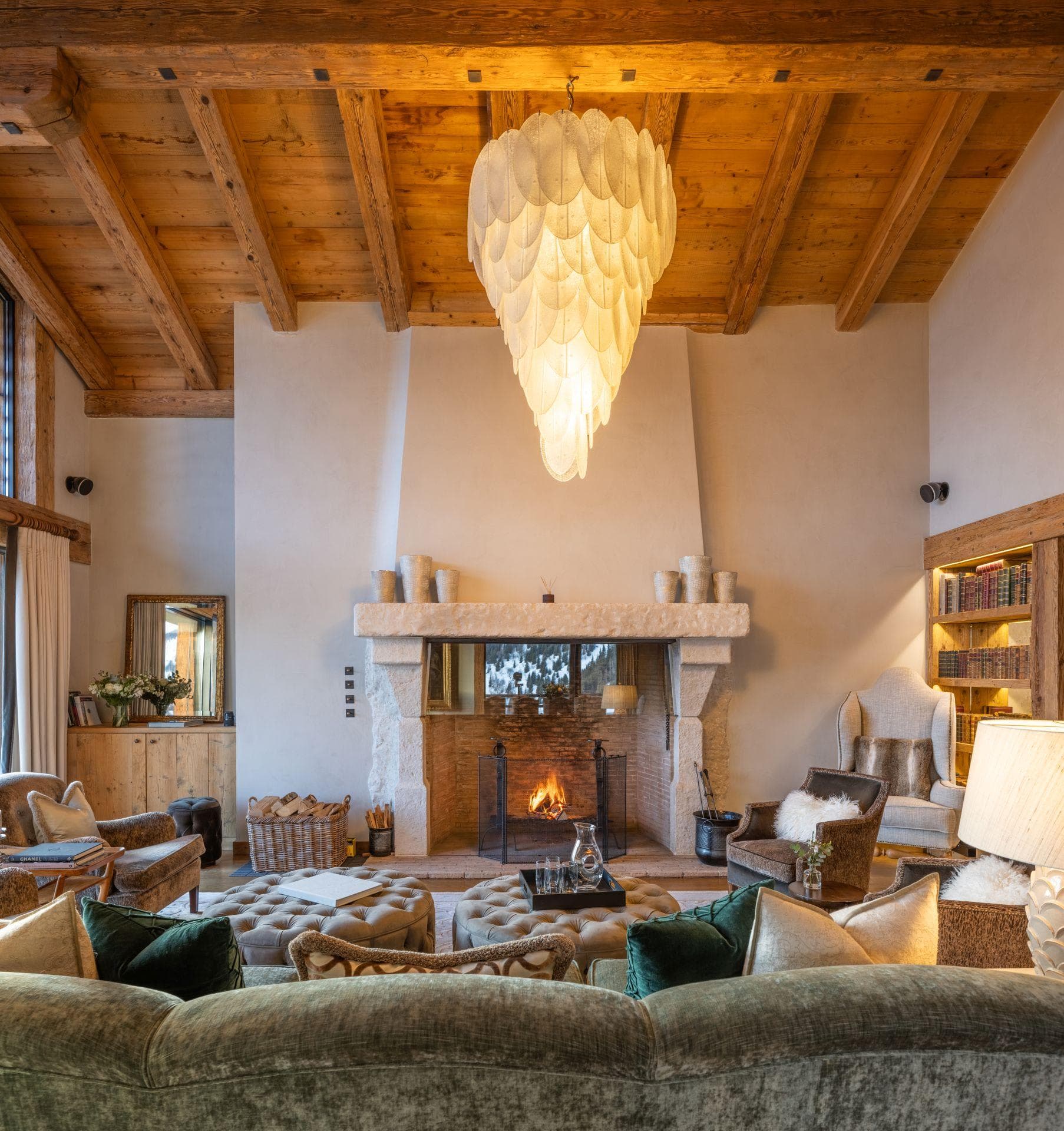 Living room with wood-burning fireplace and vaulted timber ceilings