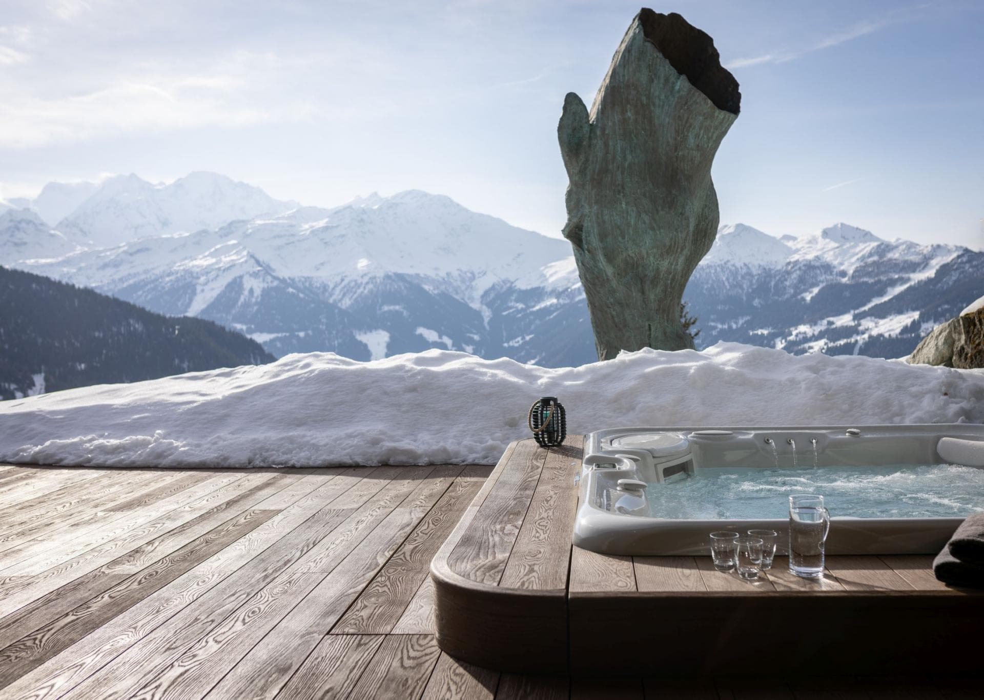 Outdoor hot tub built into deck with panoramic mountain views