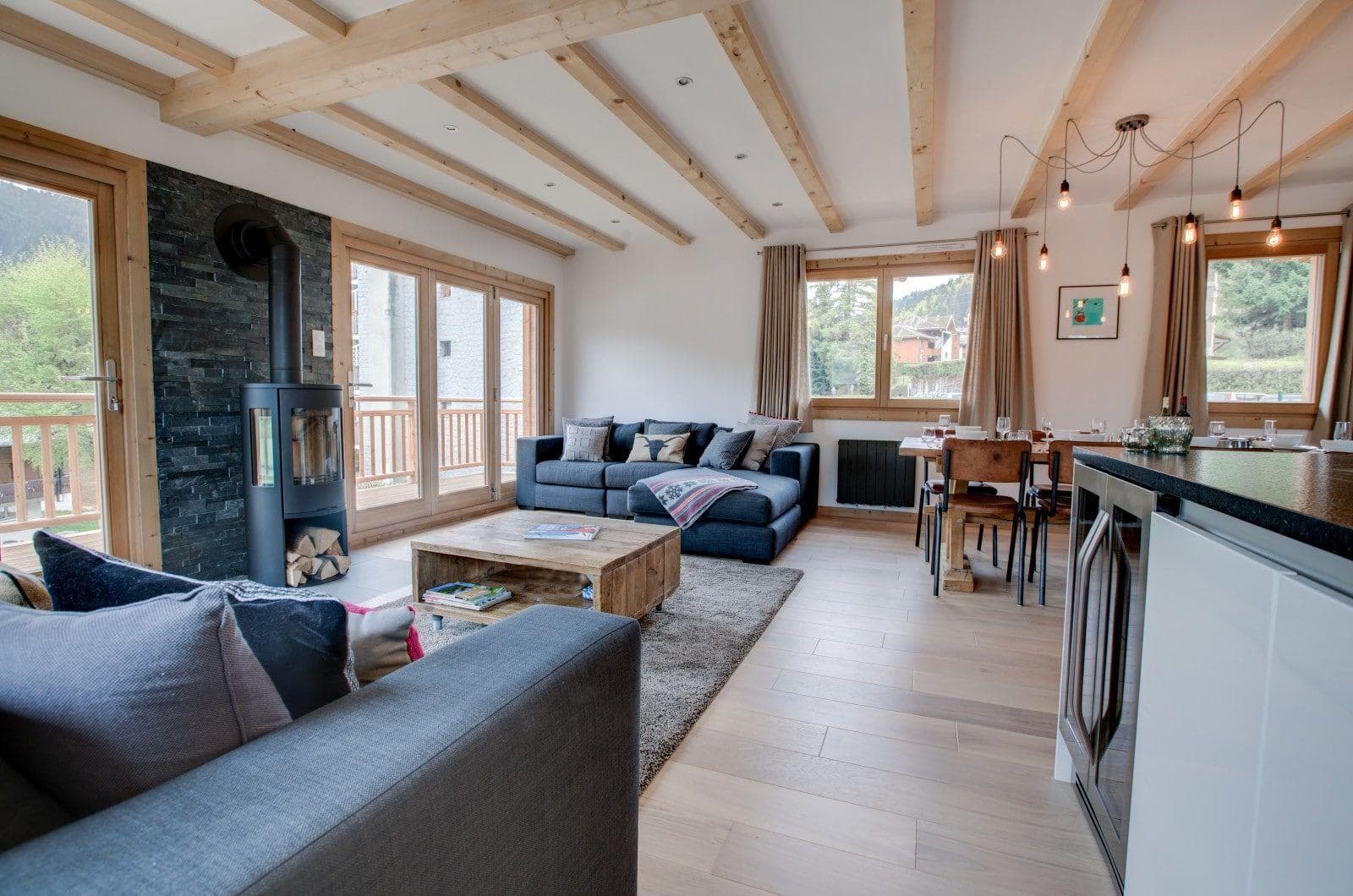 Open living area with wood-burning stove and under-counter wine fridge
