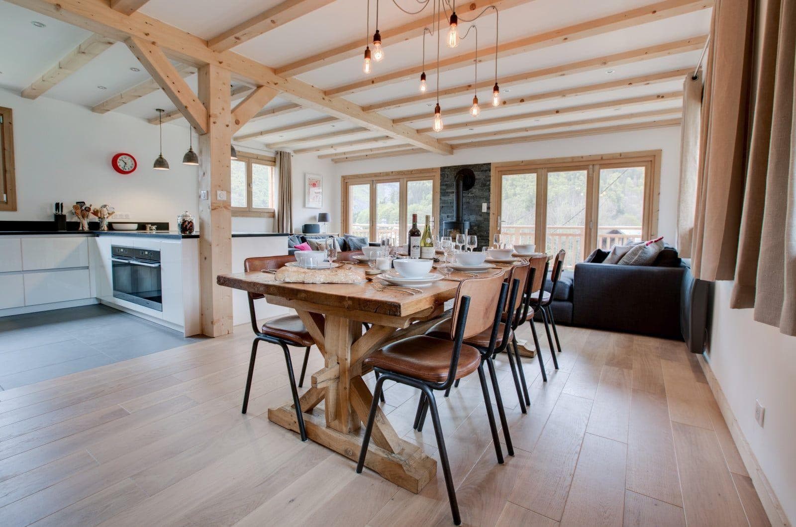 Open-plan dining area seats 8; adjacent to kitchen and wood-burning stove