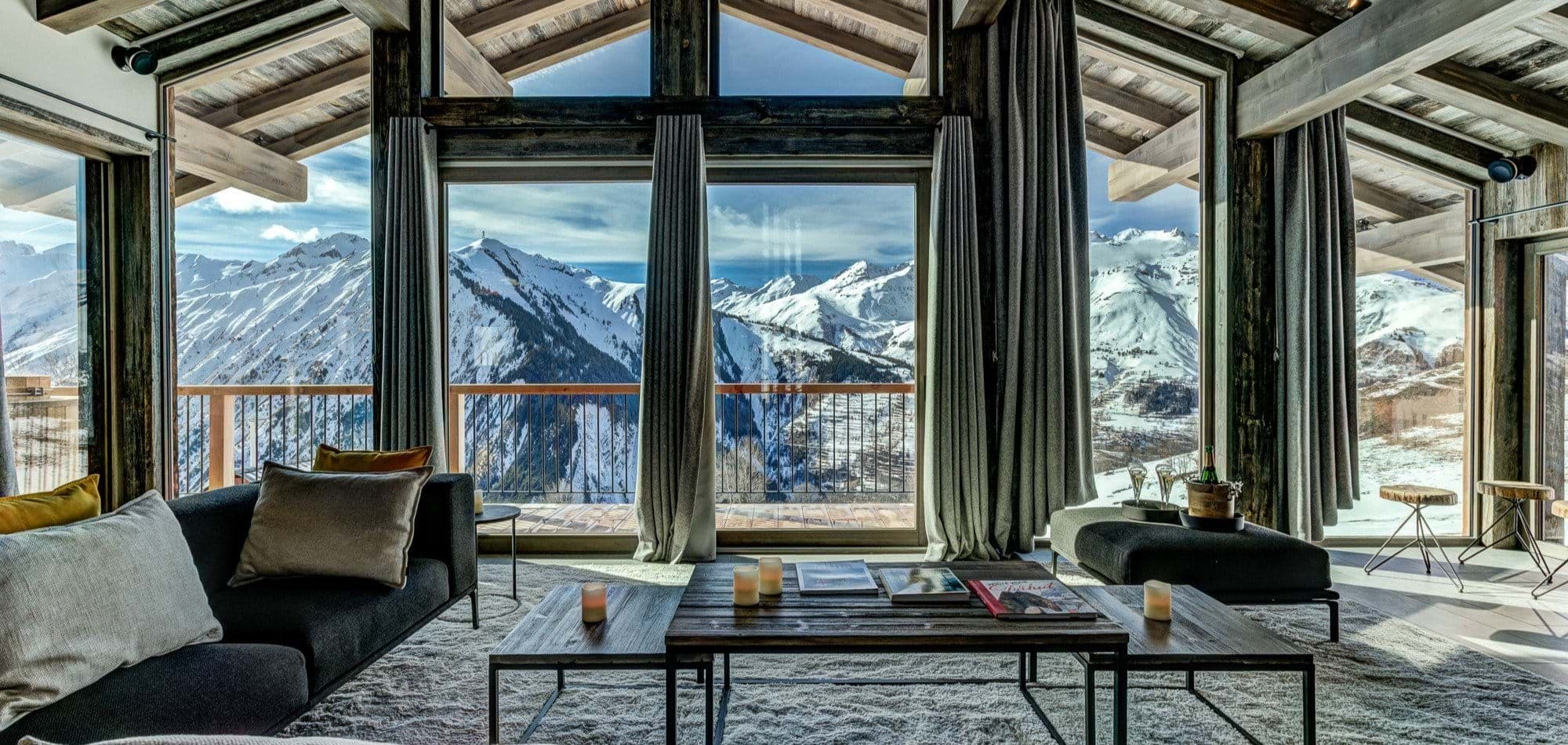 Living area with floor-to-ceiling windows and panoramic Alpine views