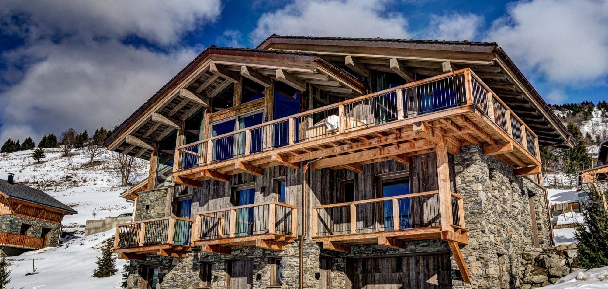 Ski-in chalet with private balconies and stone-wood architecture