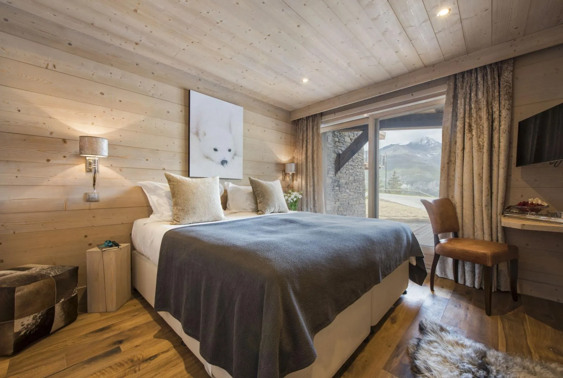 Bedroom with king bed and floor-to-ceiling mountain views