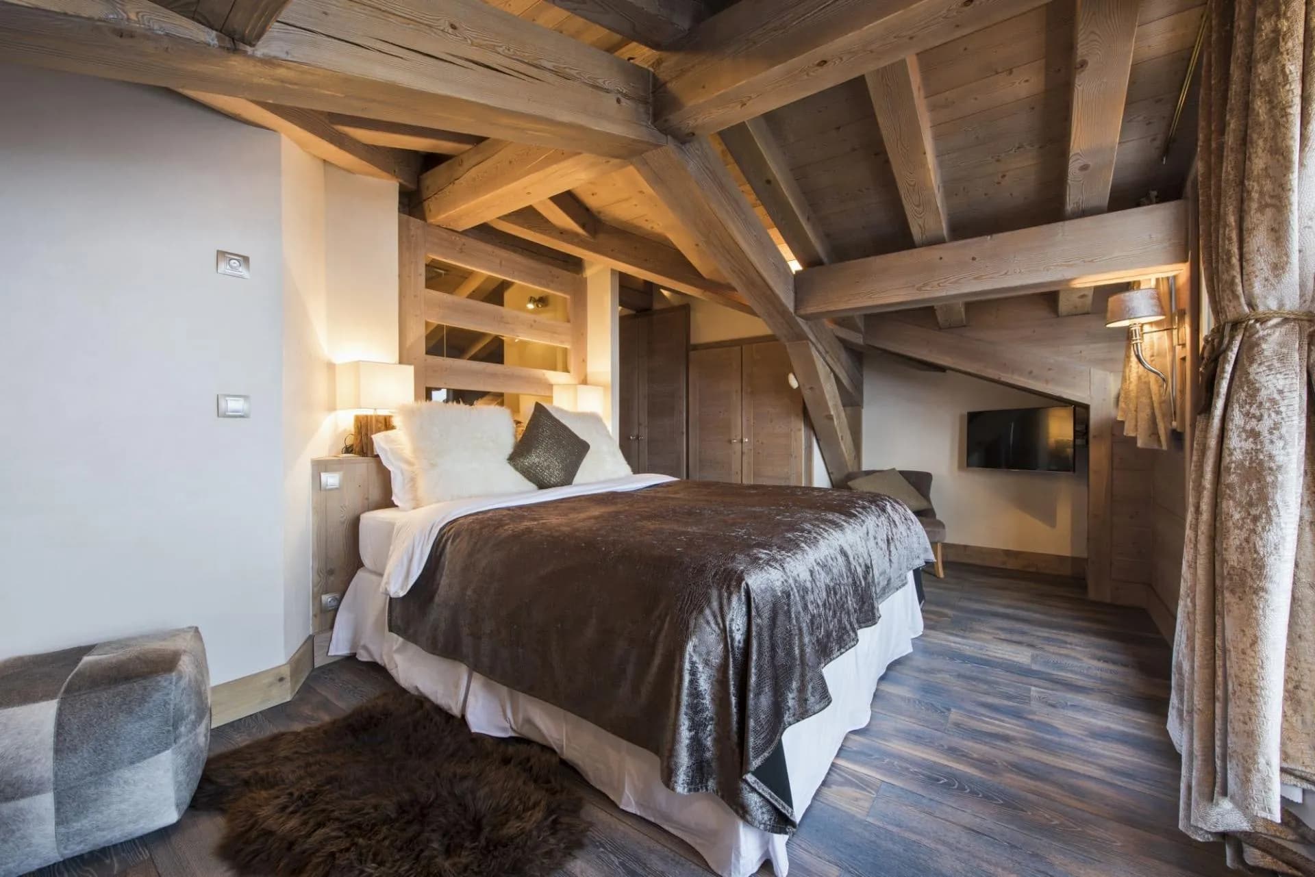 Attic bedroom with king bed and exposed timber beams