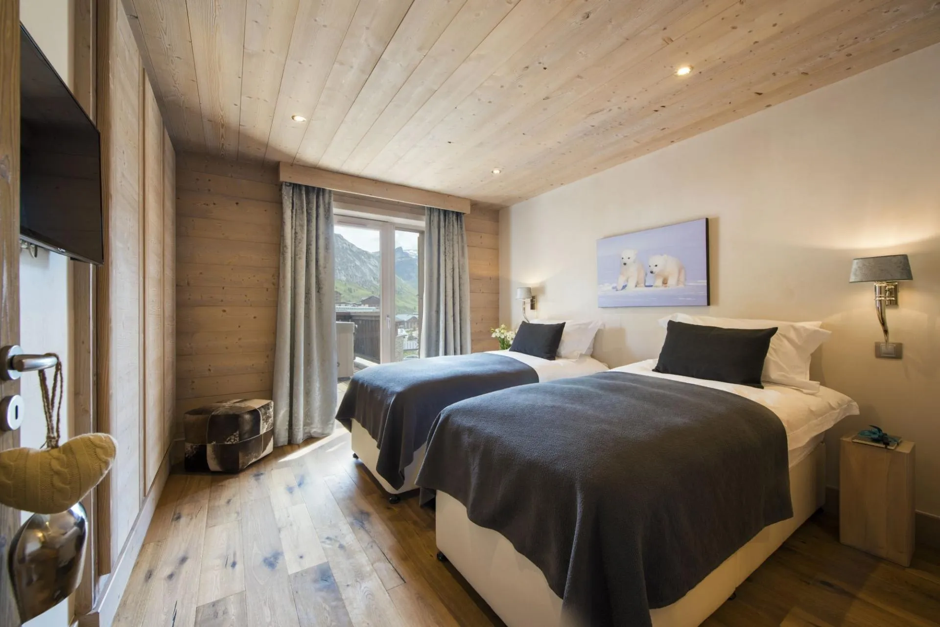 Guest bedroom with twin beds and private balcony access