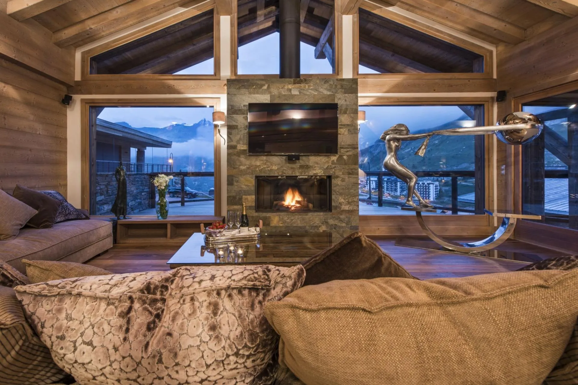 Living area with stone fireplace, smart TV, and mountain peak views