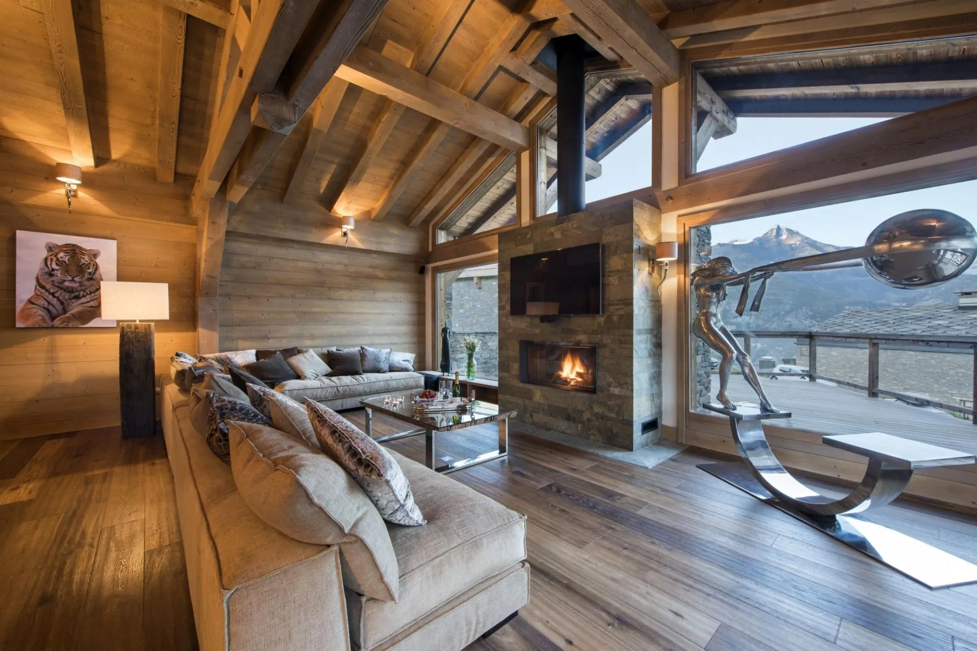 Living area with wood-burning fireplace and mountain peak views