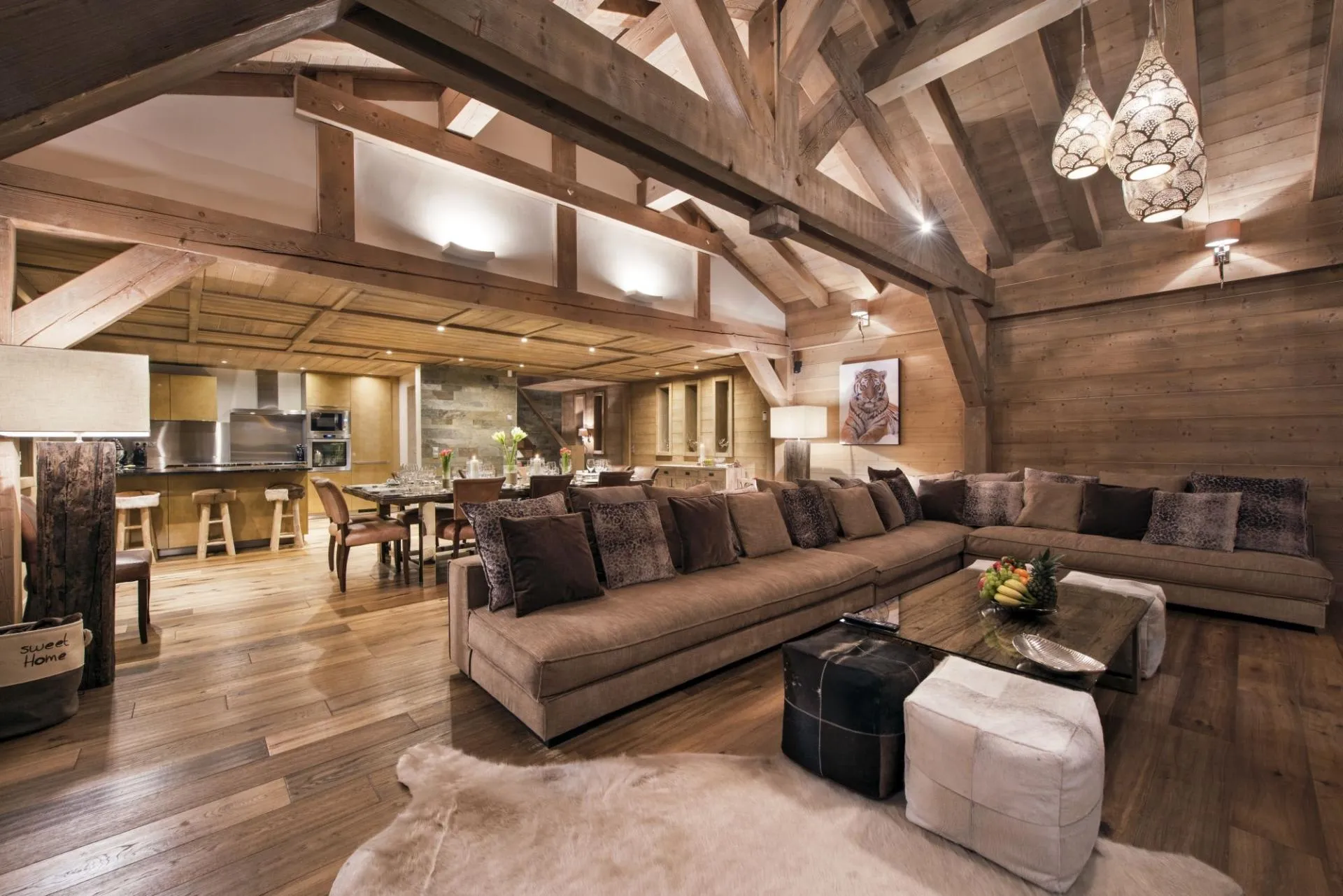 Open-plan living area with vaulted timber beams and seating for 12