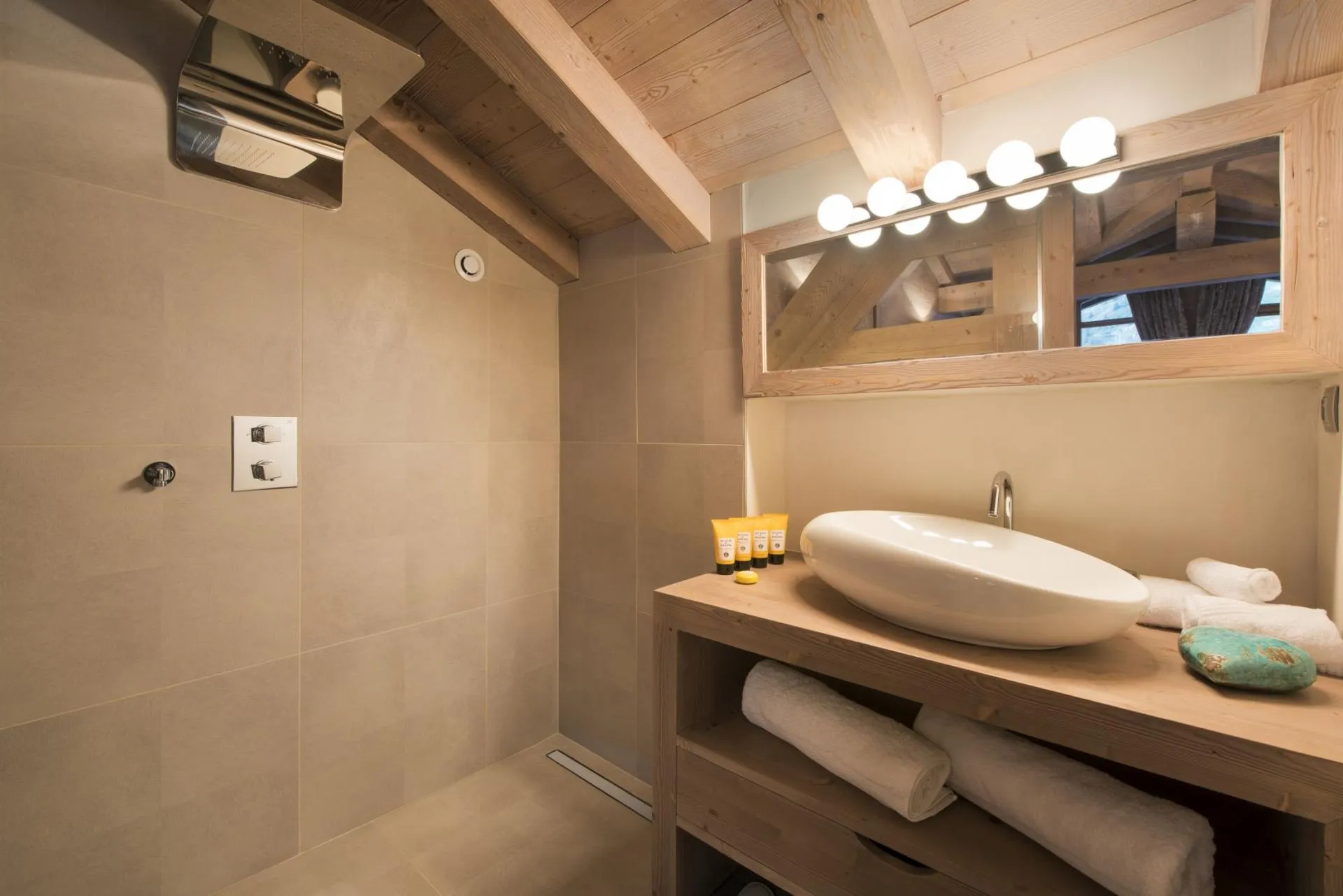 Bathroom with rainfall shower head and vessel sink vanity