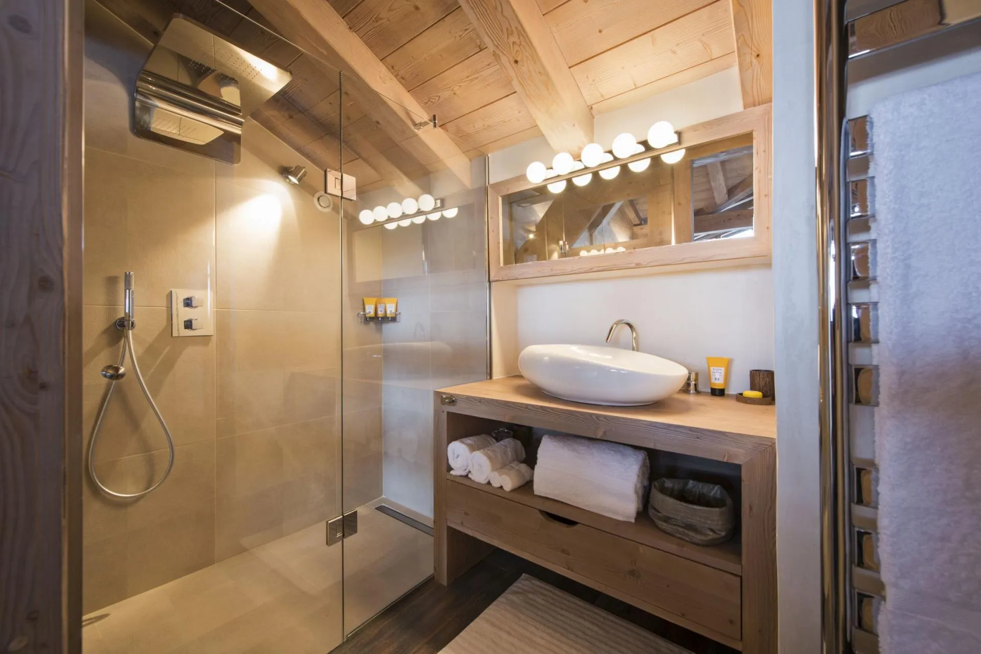 Bathroom with walk-in rainfall shower and heated towel rack
