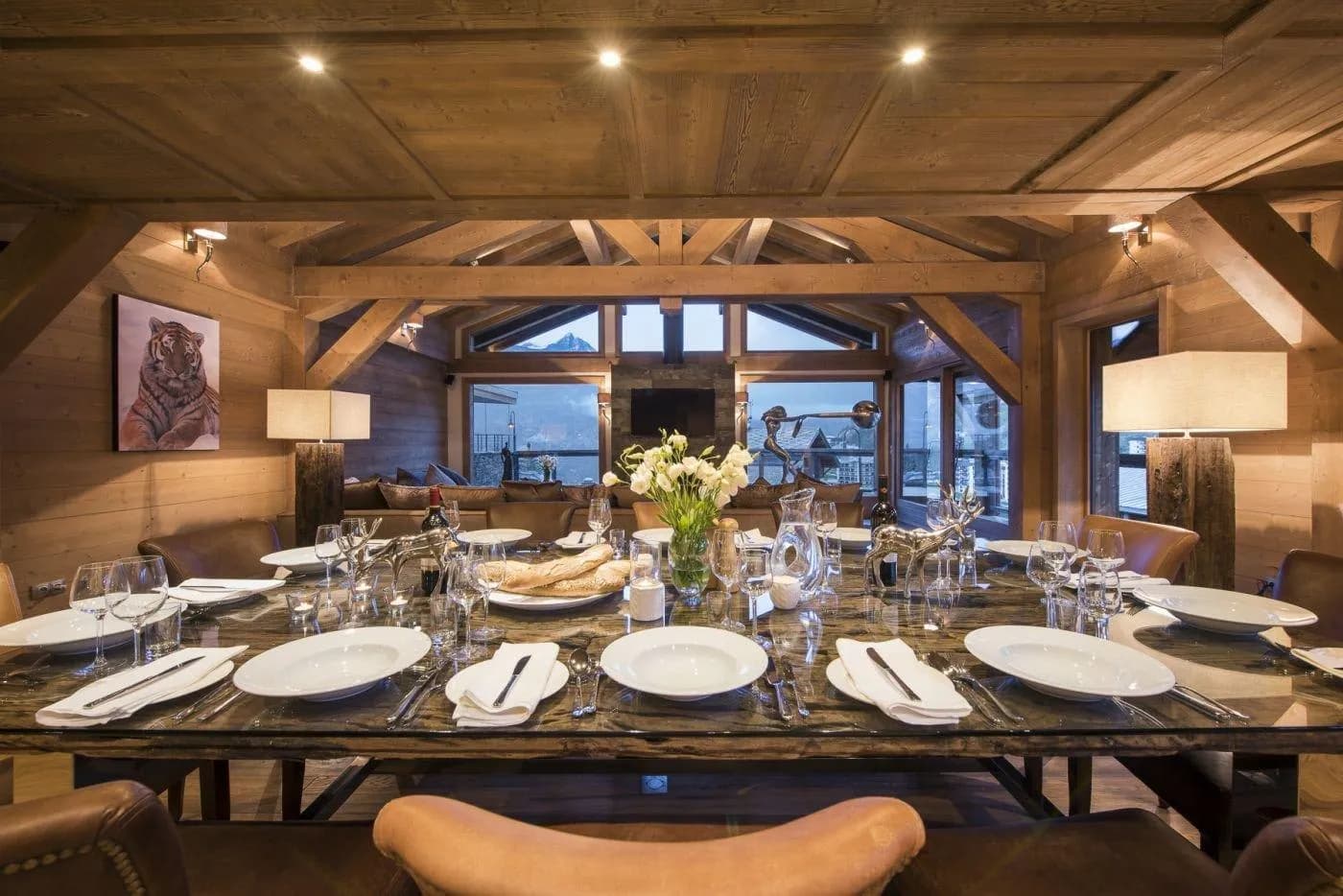 Dining area seats 12; floor-to-ceiling windows with mountain views