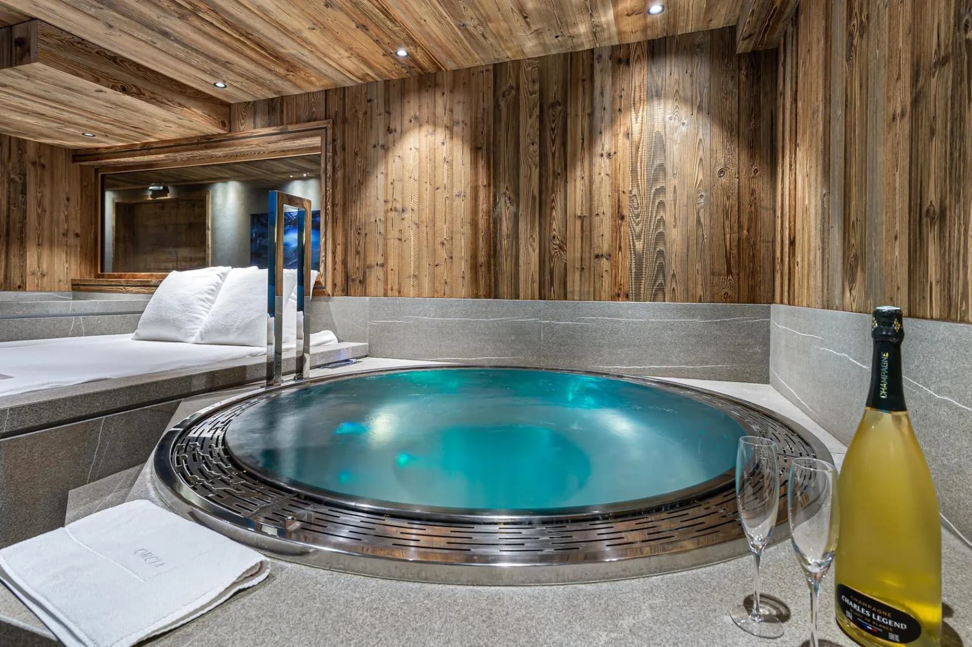 Circular indoor jacuzzi beside the pool