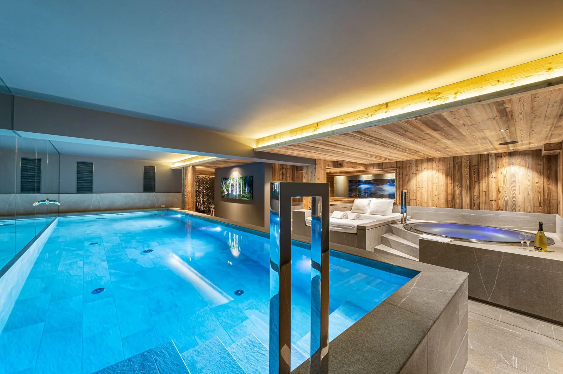Indoor swimming pool beside indoor jacuzzi