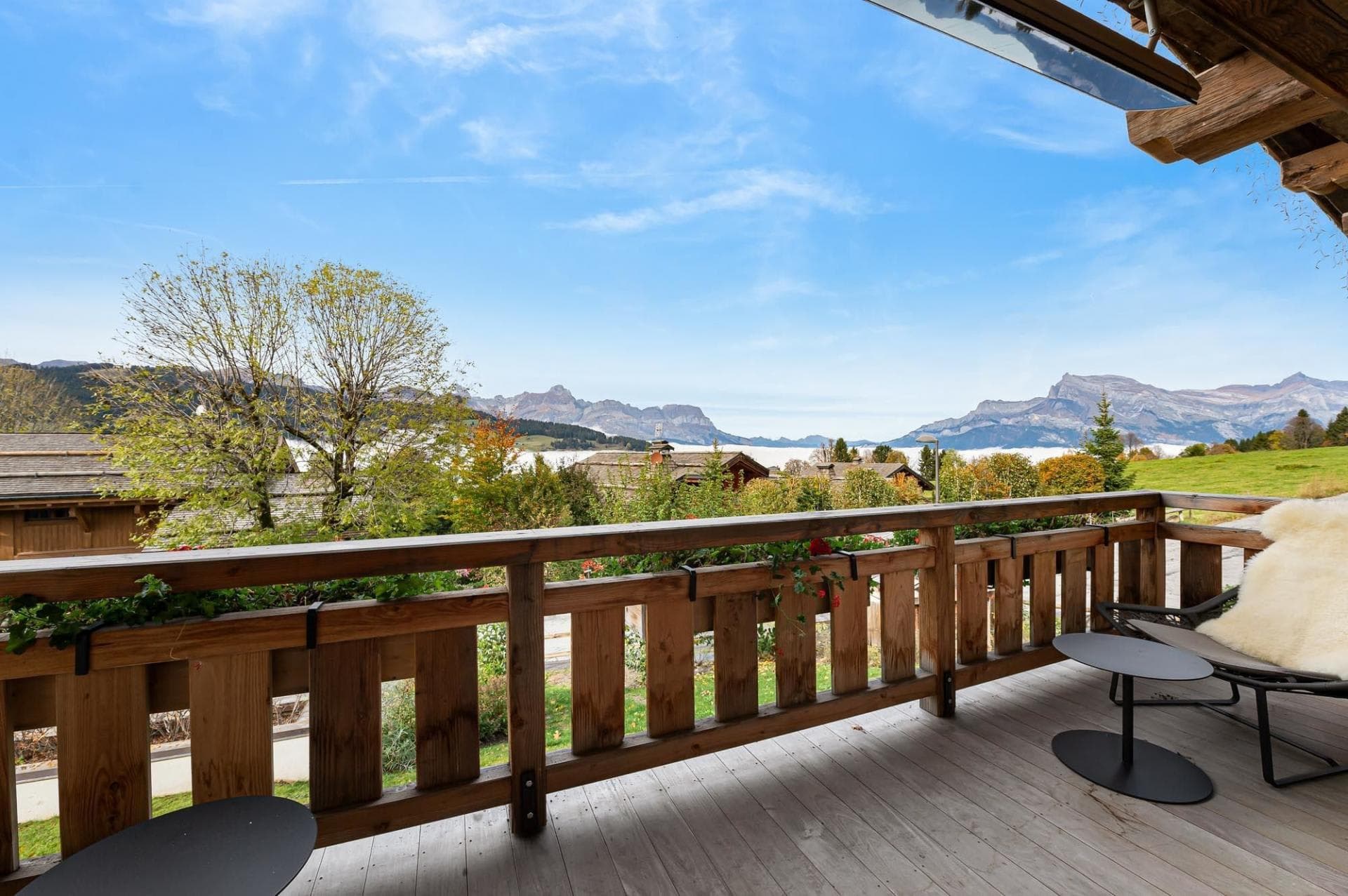 Covered balcony with lounge seating and panoramic mountain views