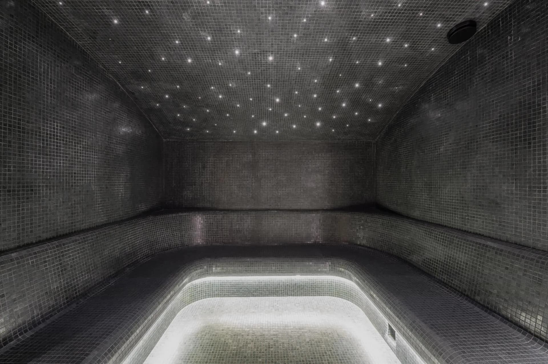 Hammam with curved seating and star-lit ceiling