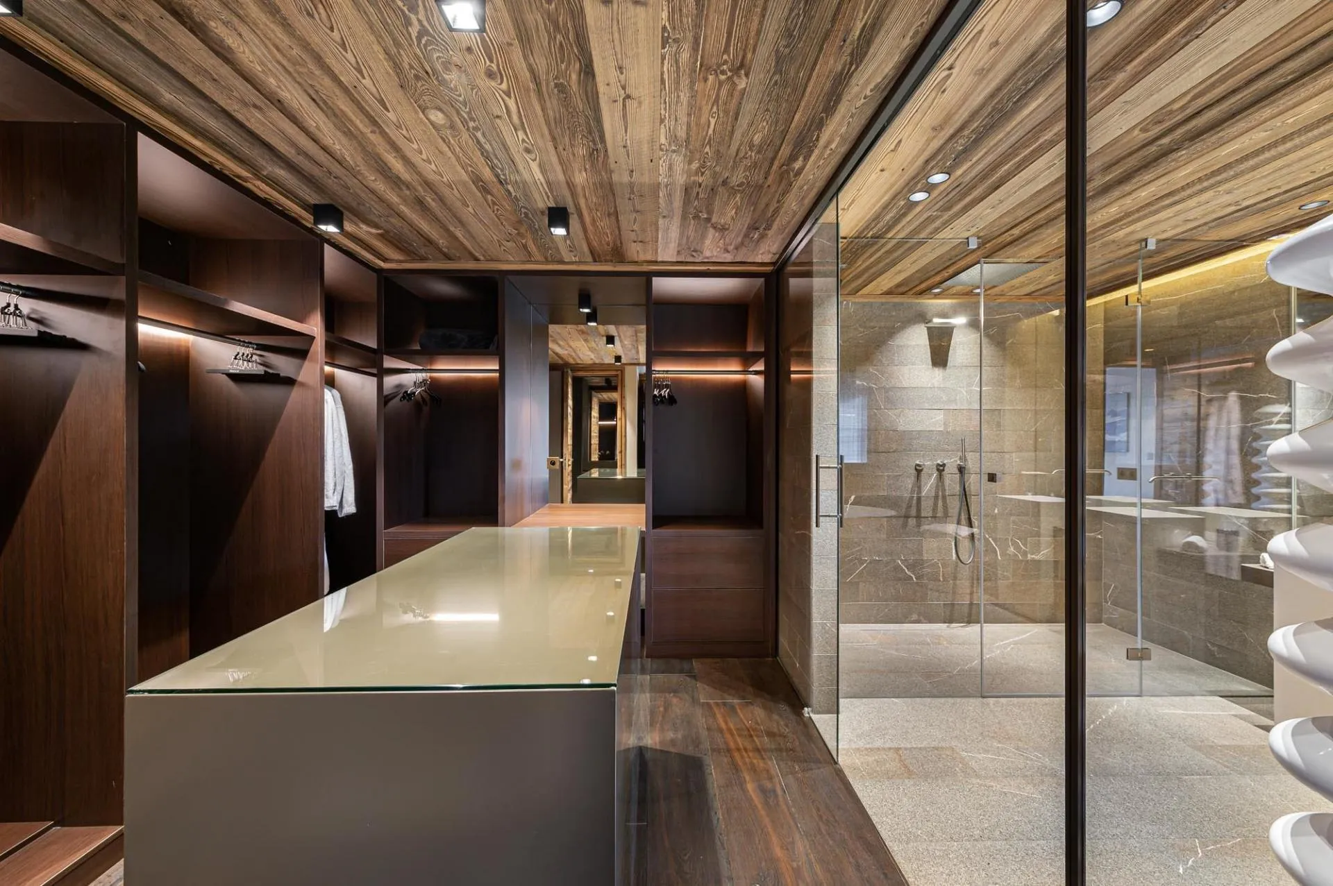 Dressing area adjoining glass-walled walk-in shower