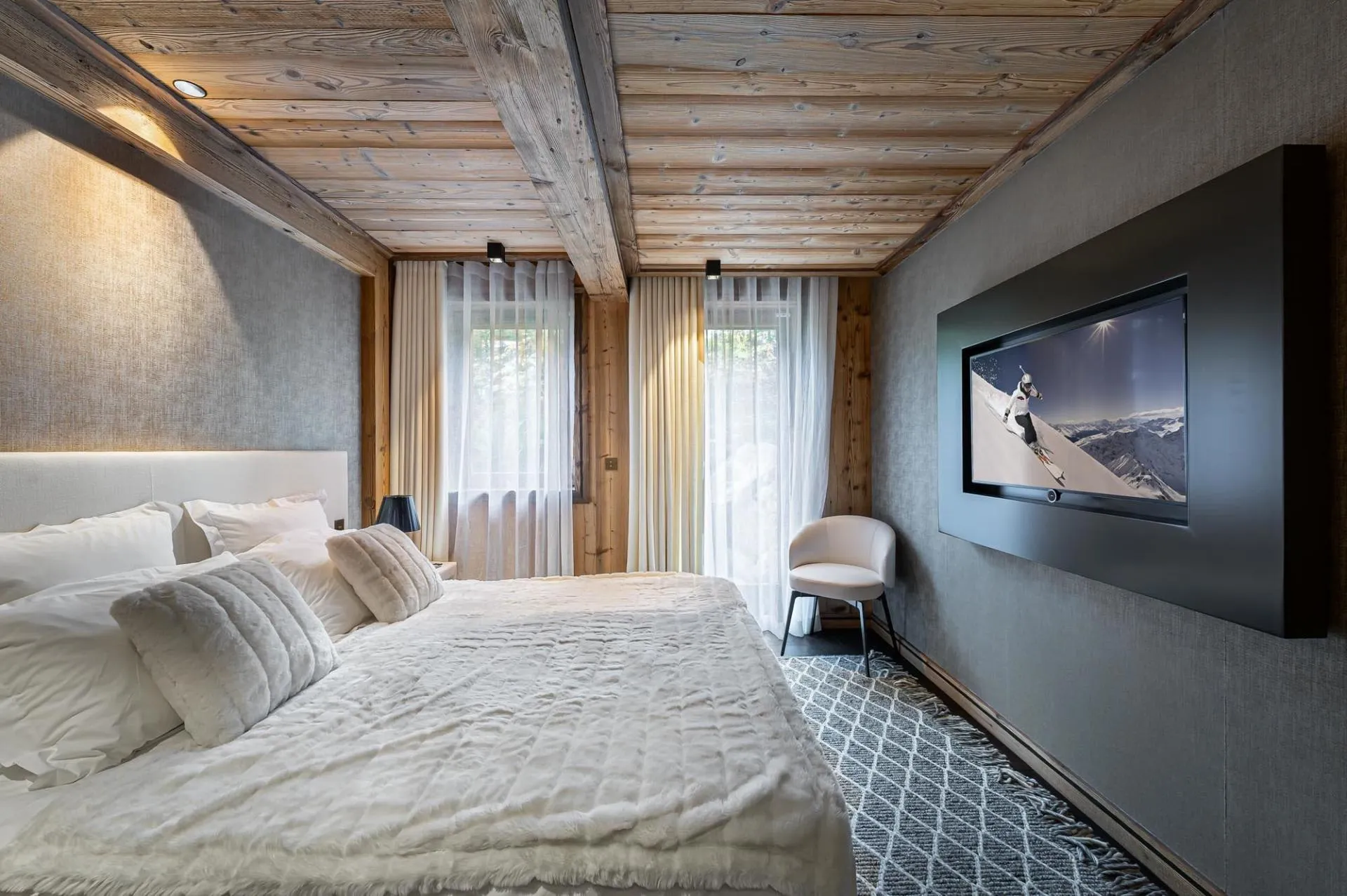 Double bedroom with television and timber walls