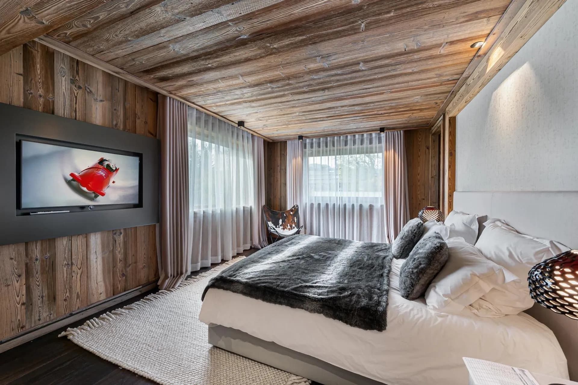 Double bedroom with television and timber ceiling