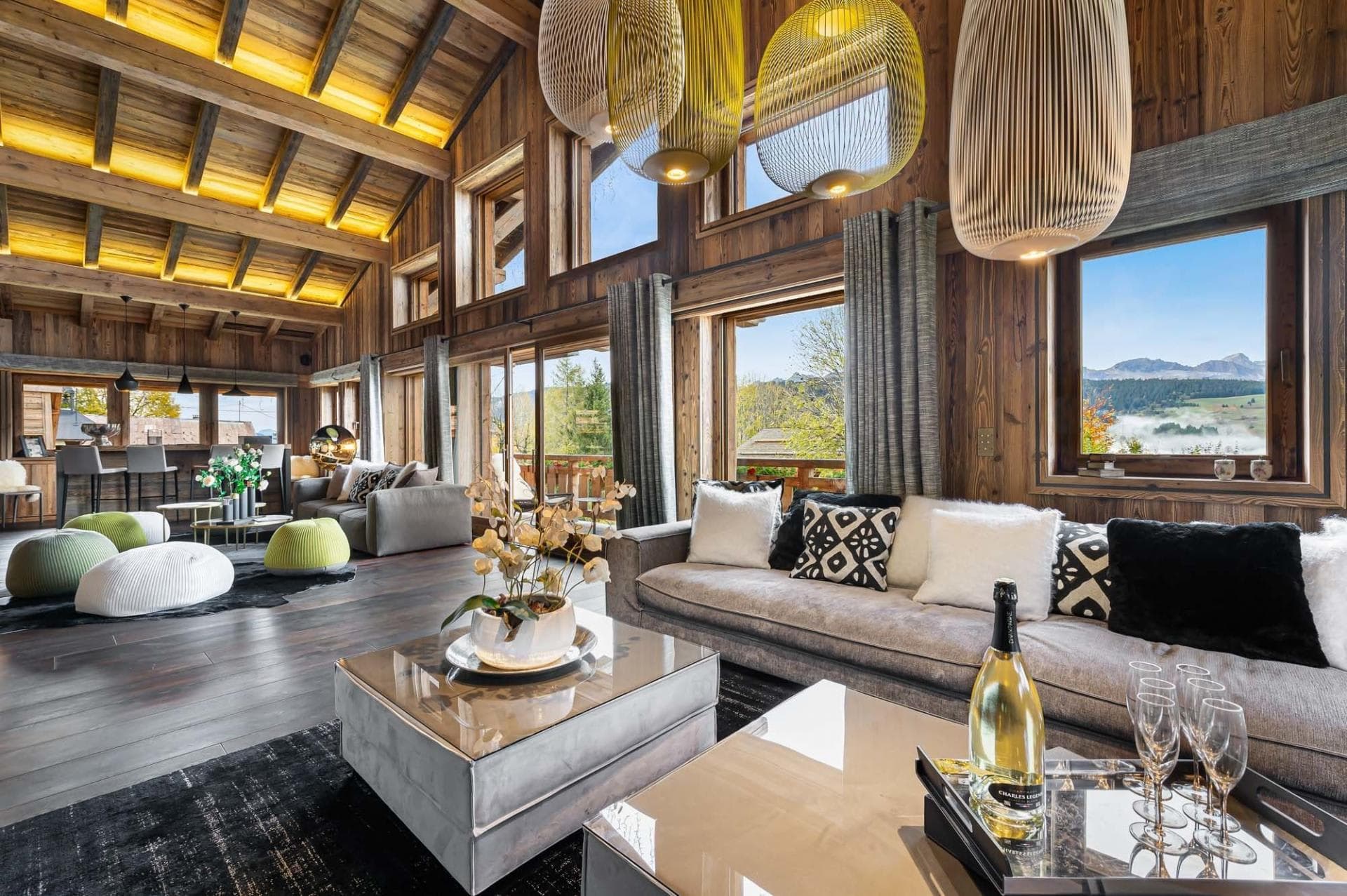 Open-plan living area with vaulted timber ceilings and valley views