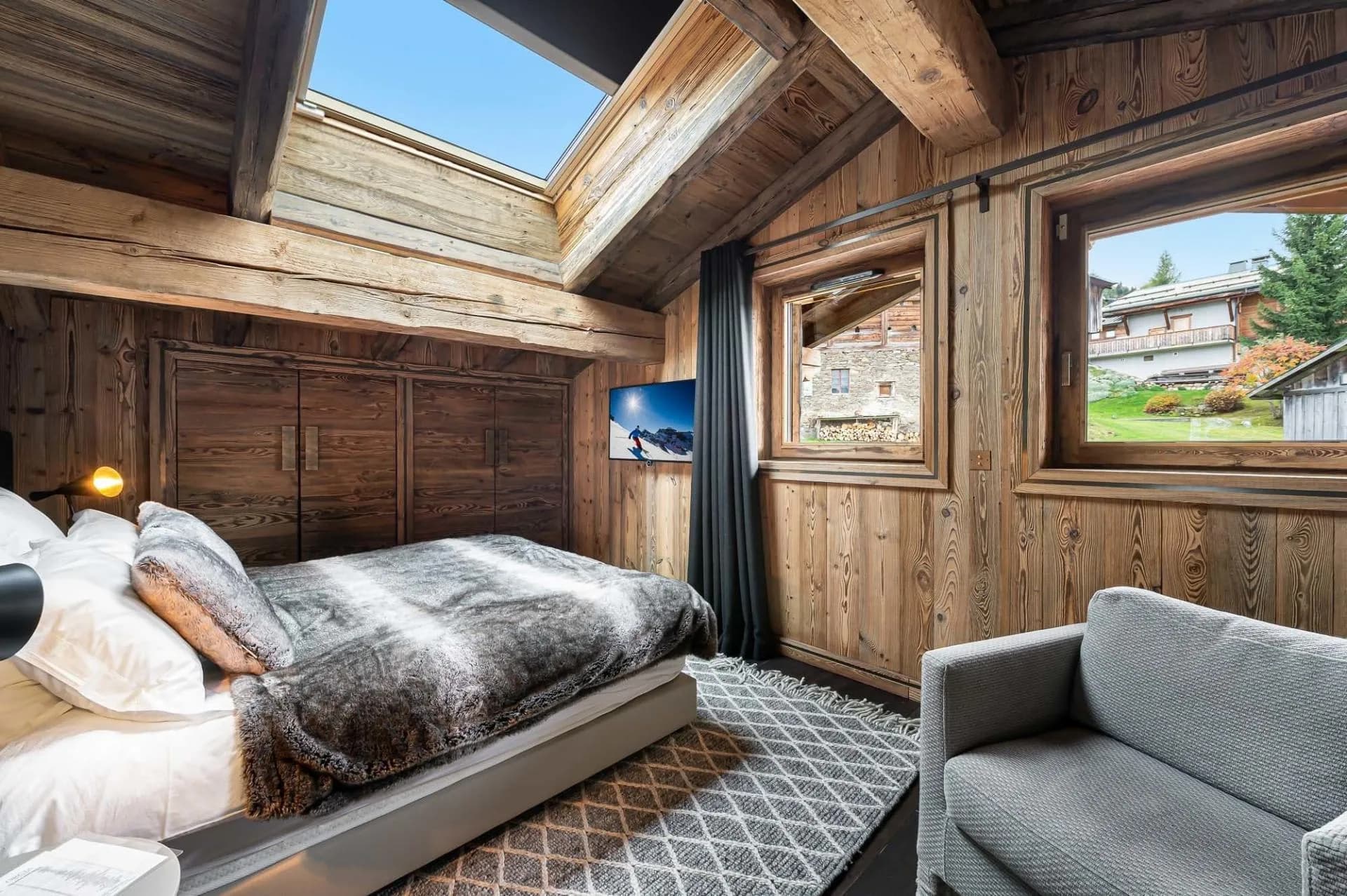 Double bedroom beneath beams with skylight and windows