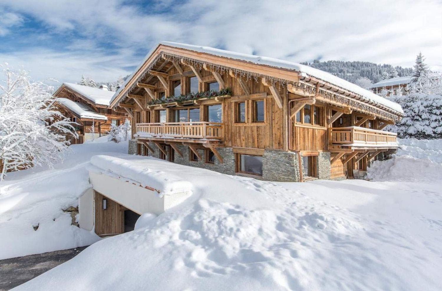 Ski-in chalet exterior with underground garage and wrap-around balconies