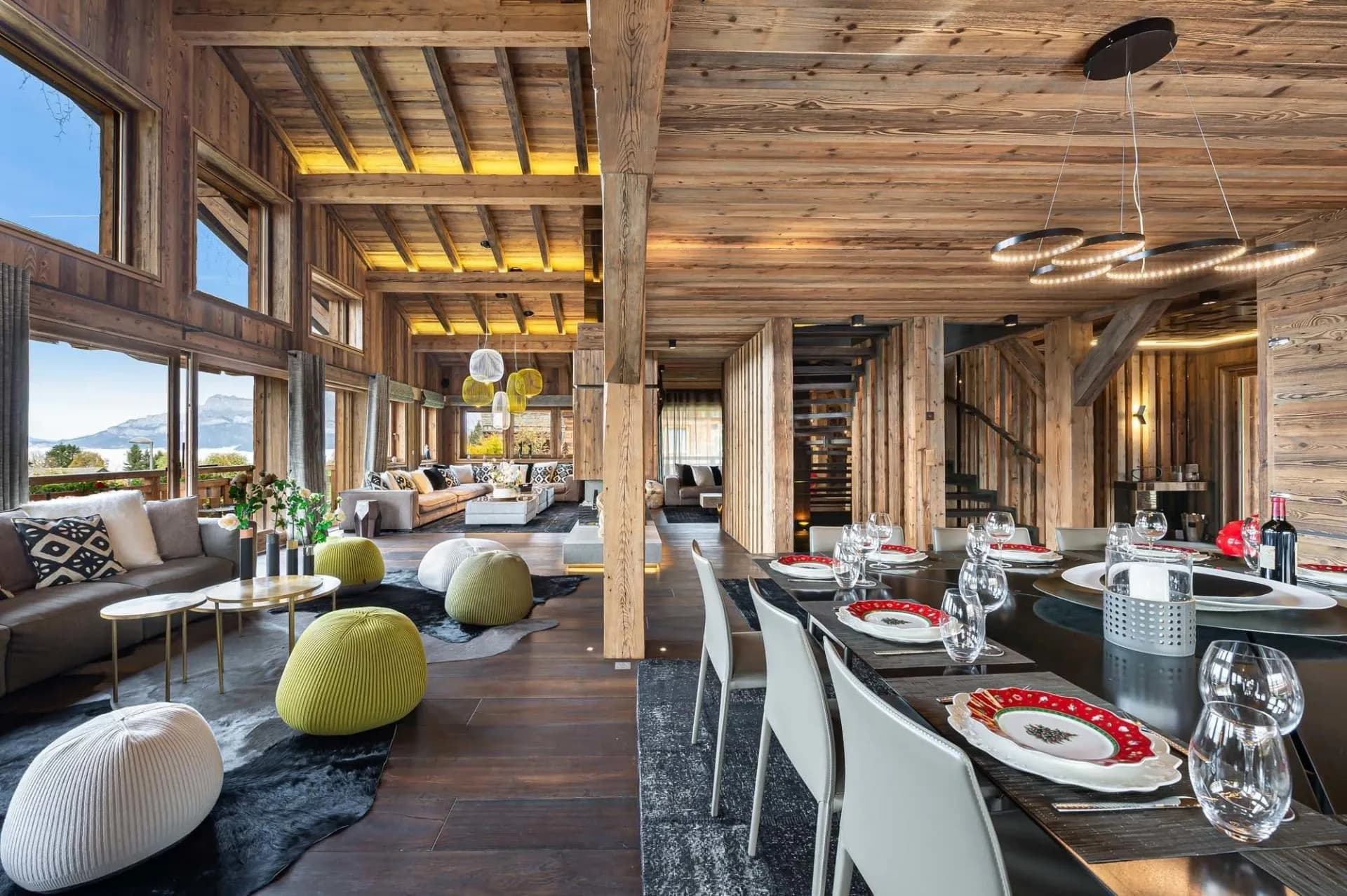 Dining and living space with high windows and timber ceiling