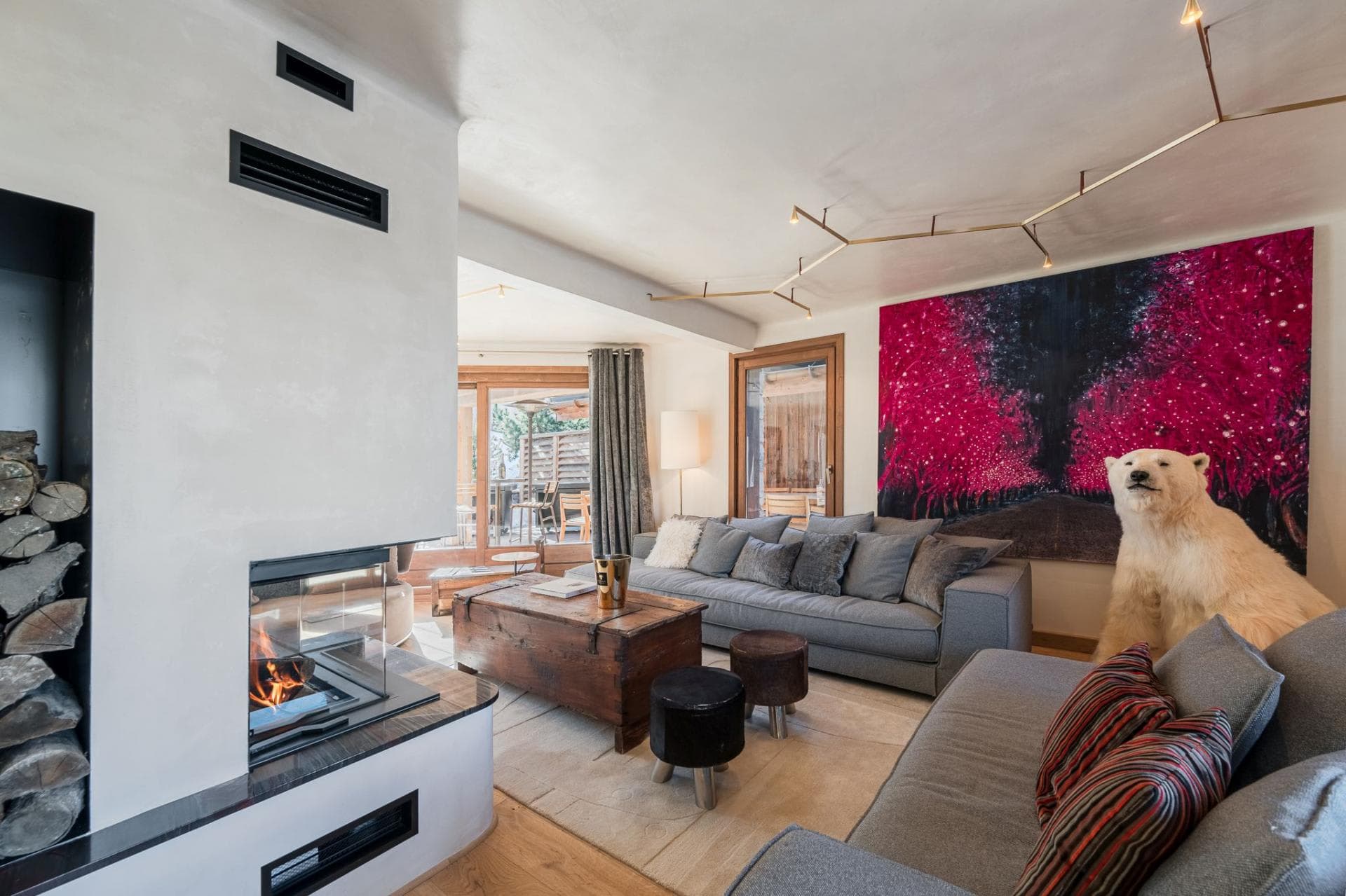Living area with wood-burning fireplace and direct terrace access