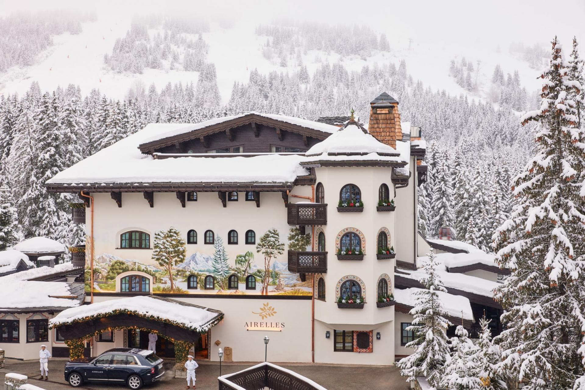 Chalet exterior with hand-painted murals and snowy mountain backdrop