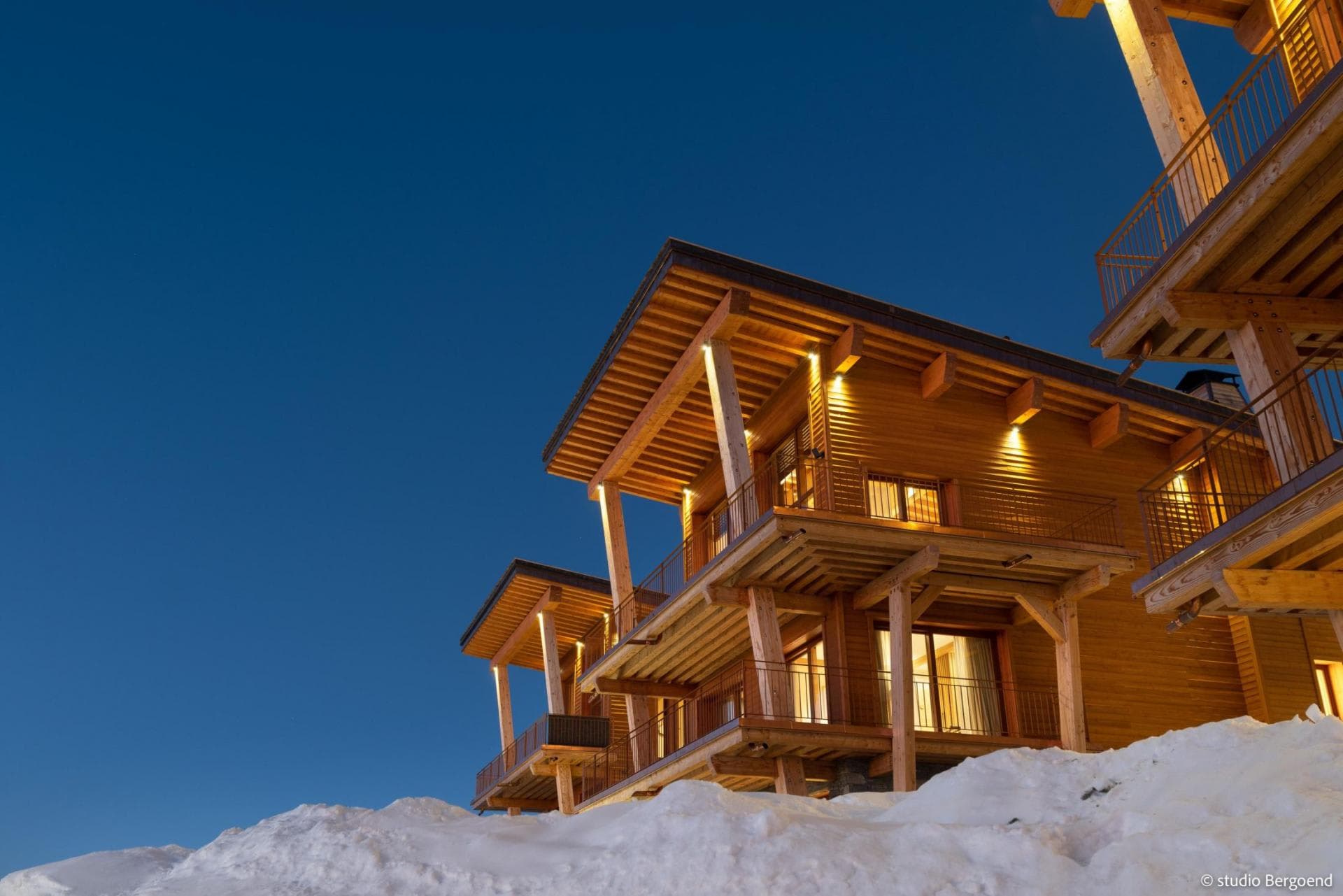 Ski-in/ski-out chalet with private wrap-around balconies and exterior lighting