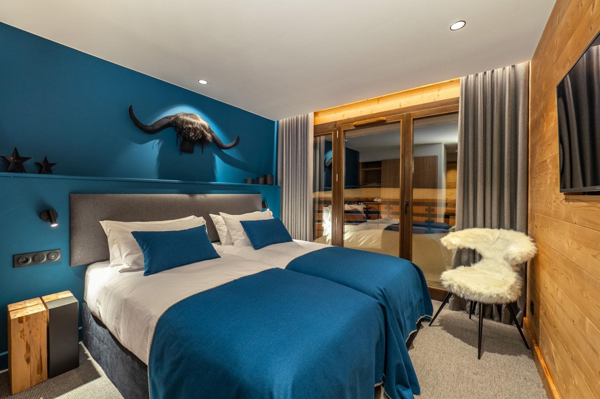 Guest bedroom with two twin beds and private balcony access