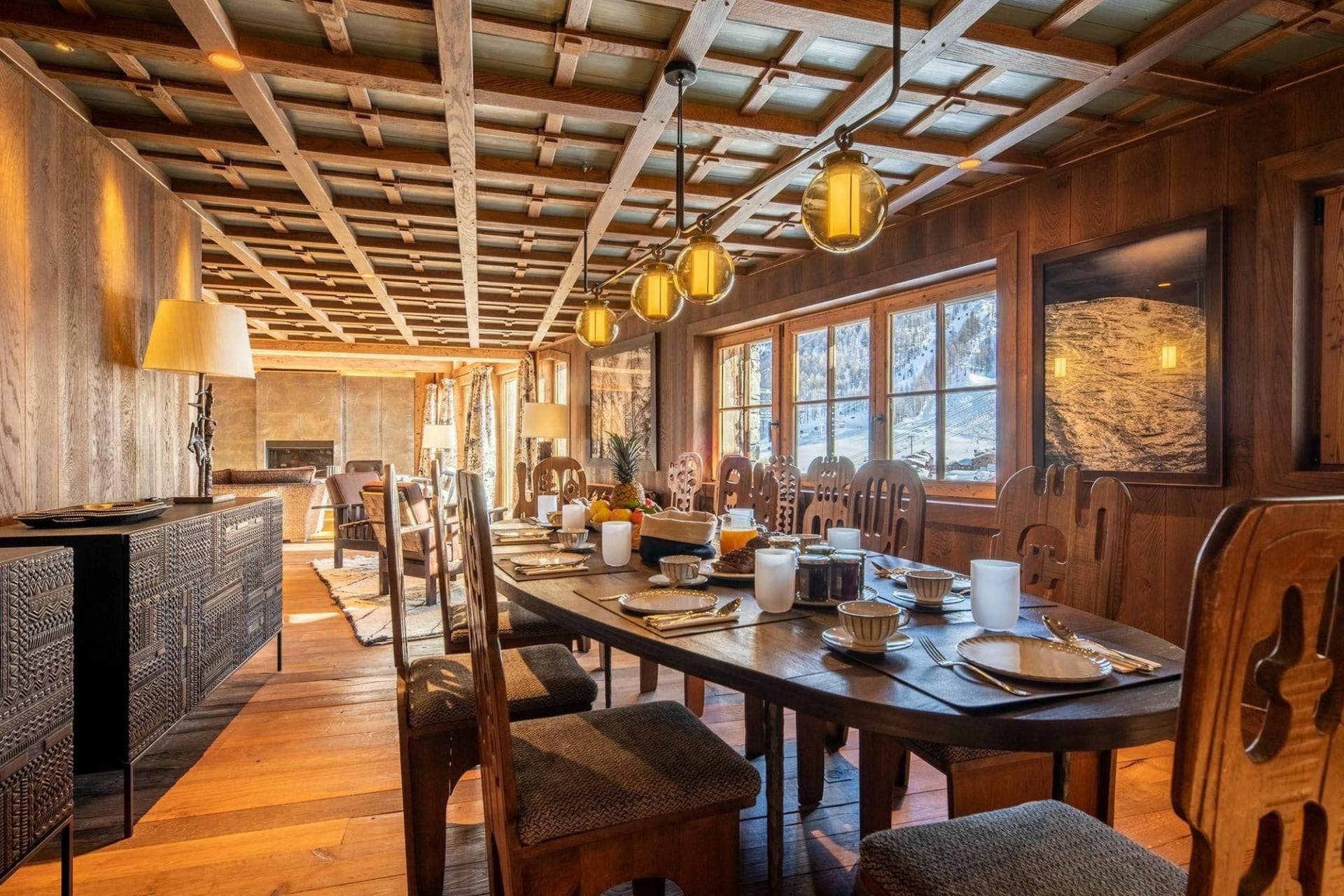 Dining table seats 10 with mountain views and coffered wood ceiling