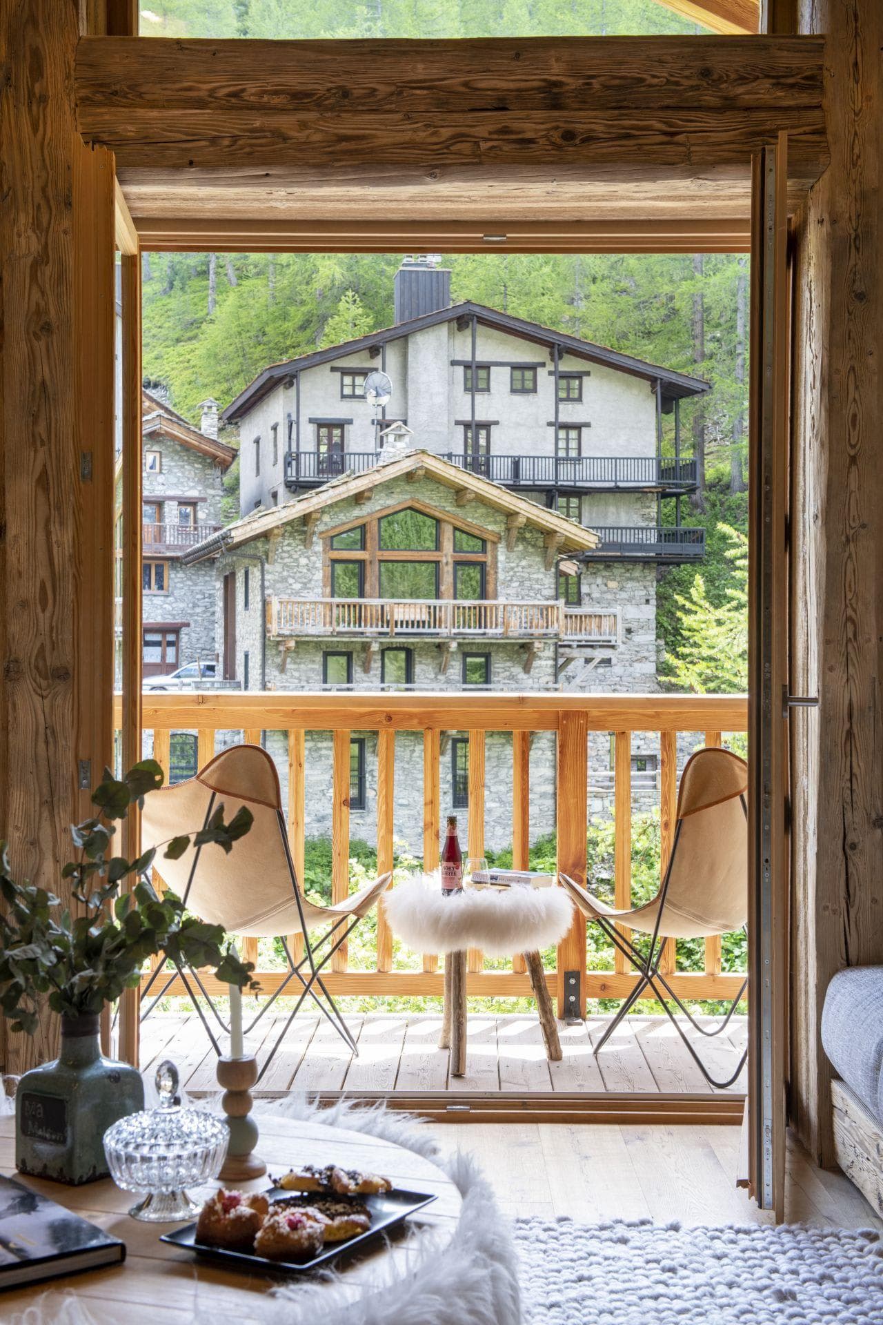 Private balcony with butterfly chair seating and village views
