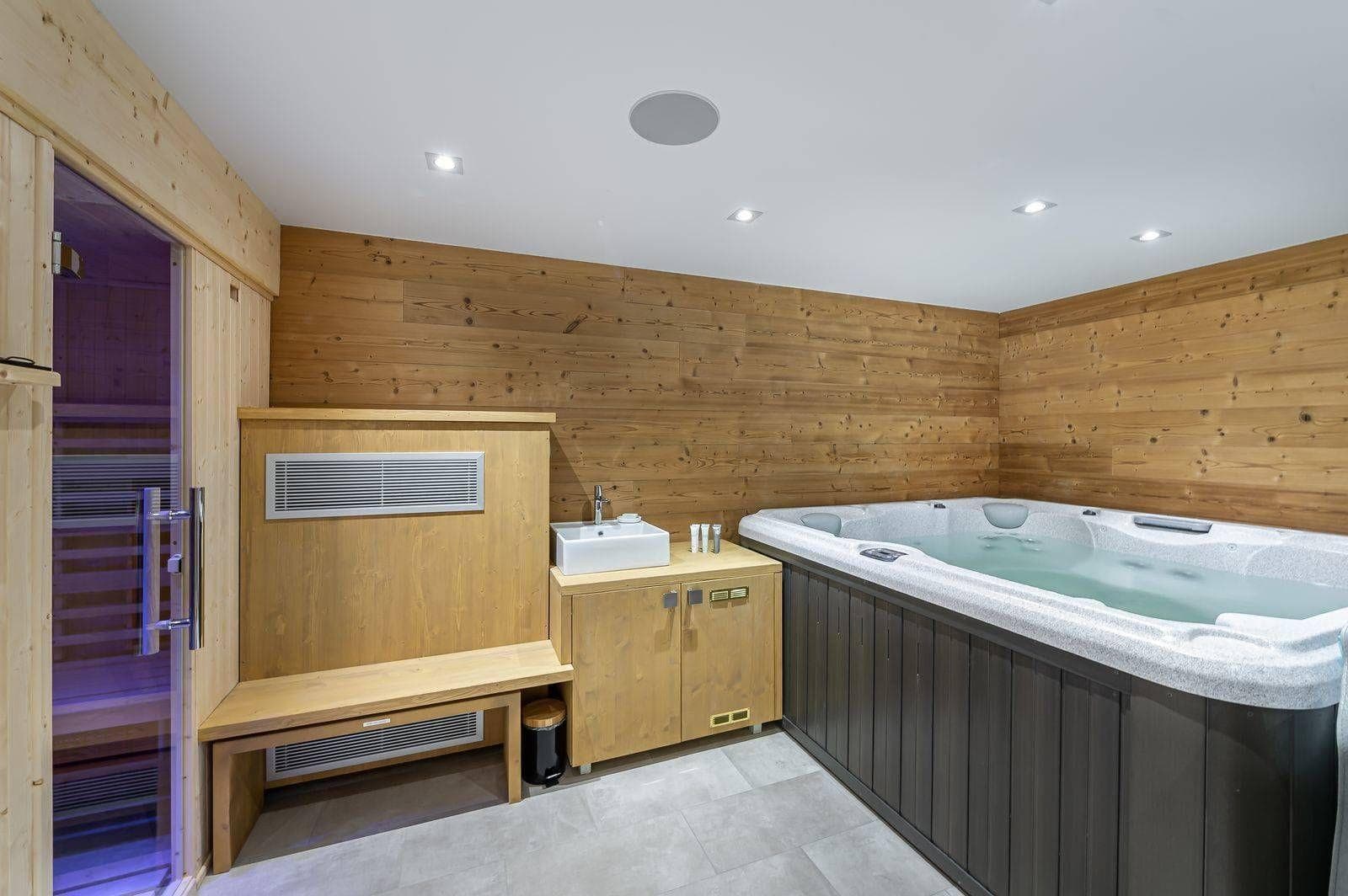 Indoor spa area with jetted hot tub and private sauna access