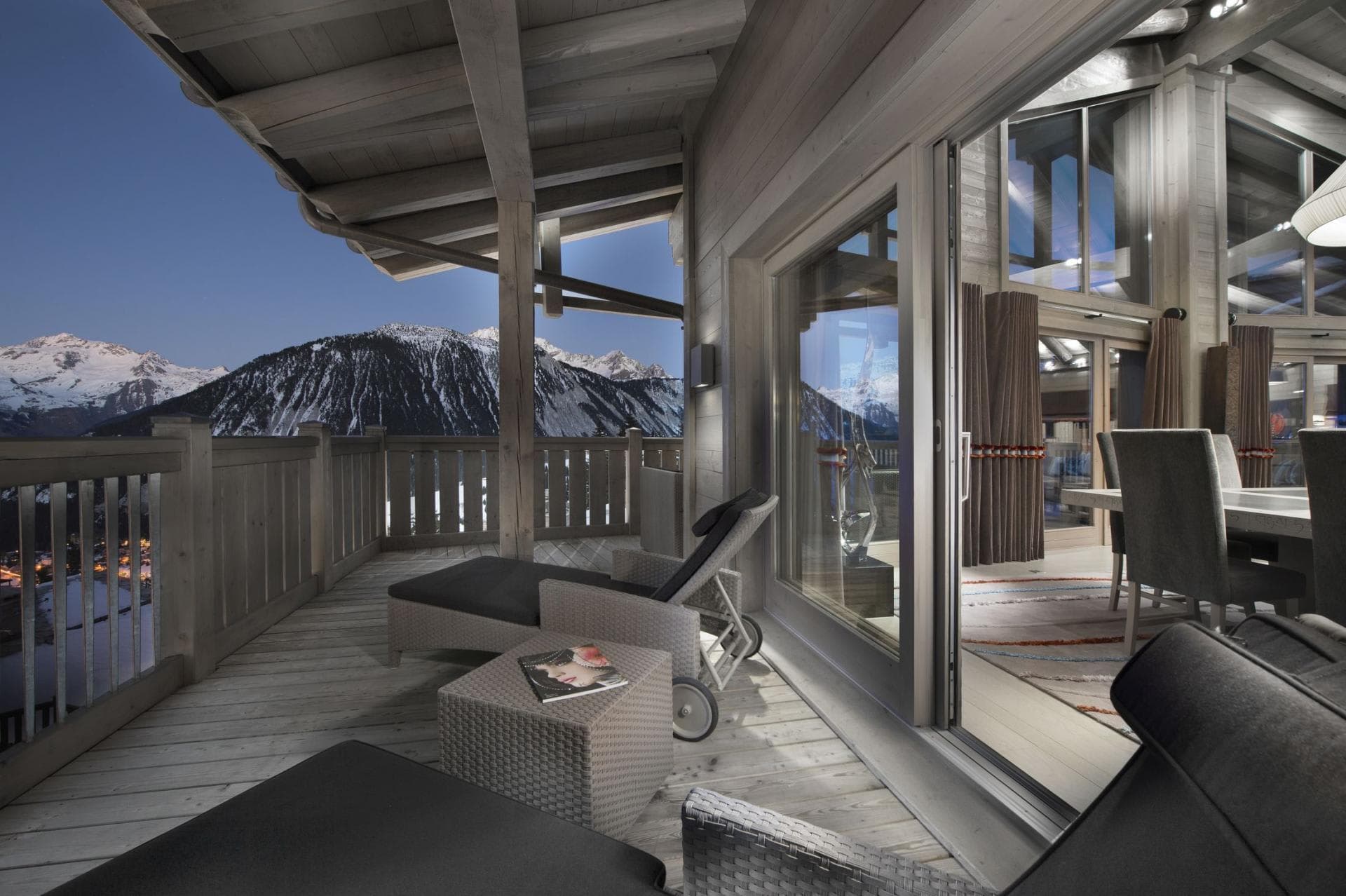 Covered timber balcony with lounge seating and panoramic mountain views