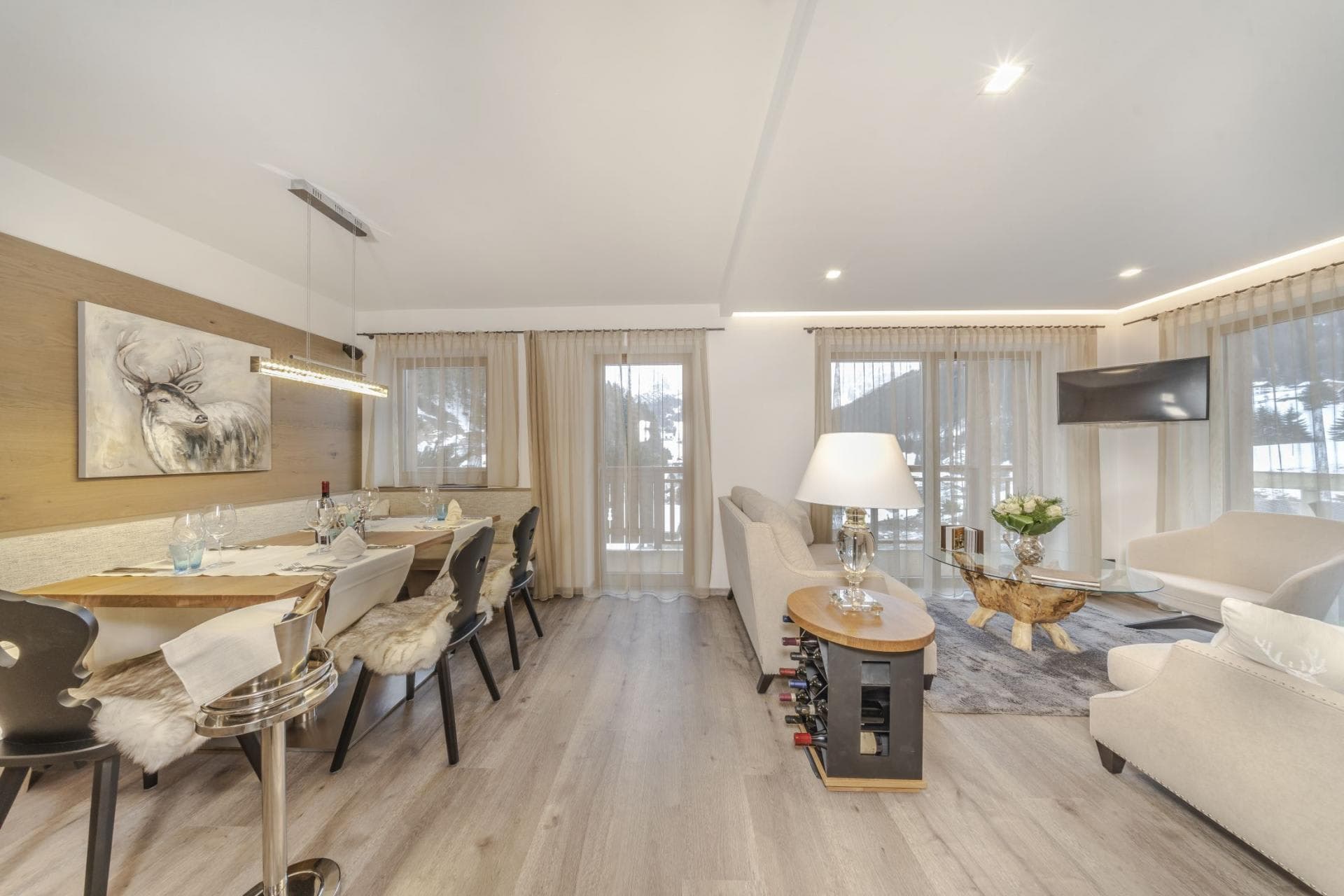 Open-plan living and dining area with balcony access and wine storage
