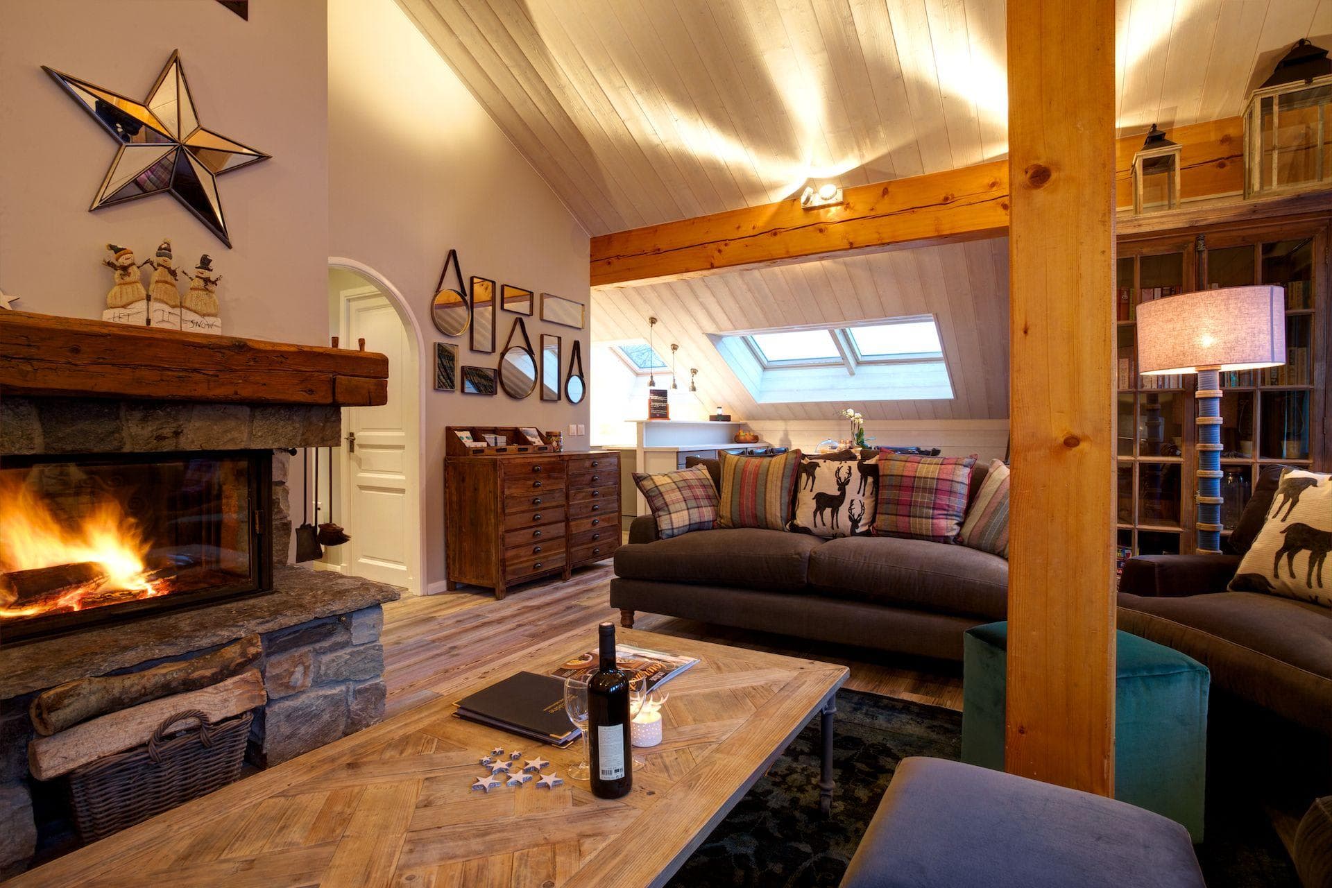 Living area with wood-burning fireplace and skylights for natural light