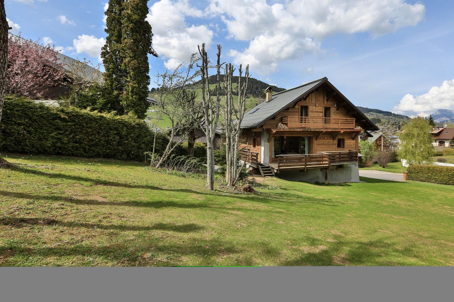 Timber chalet exterior with private lawn and wrap-around sun deck
