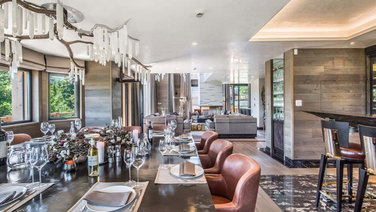 Dining area with antler chandelier, leather seating, and mountain views