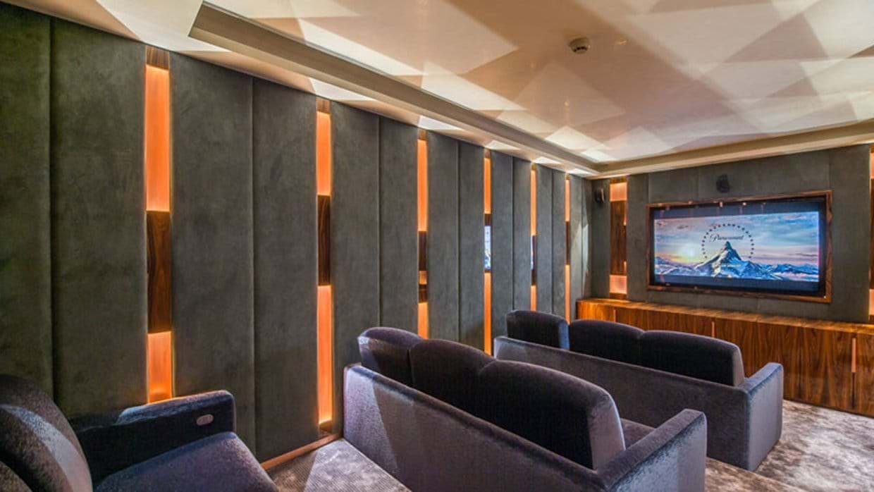 Private cinema room with tiered velvet sofa seating for 8 guests
