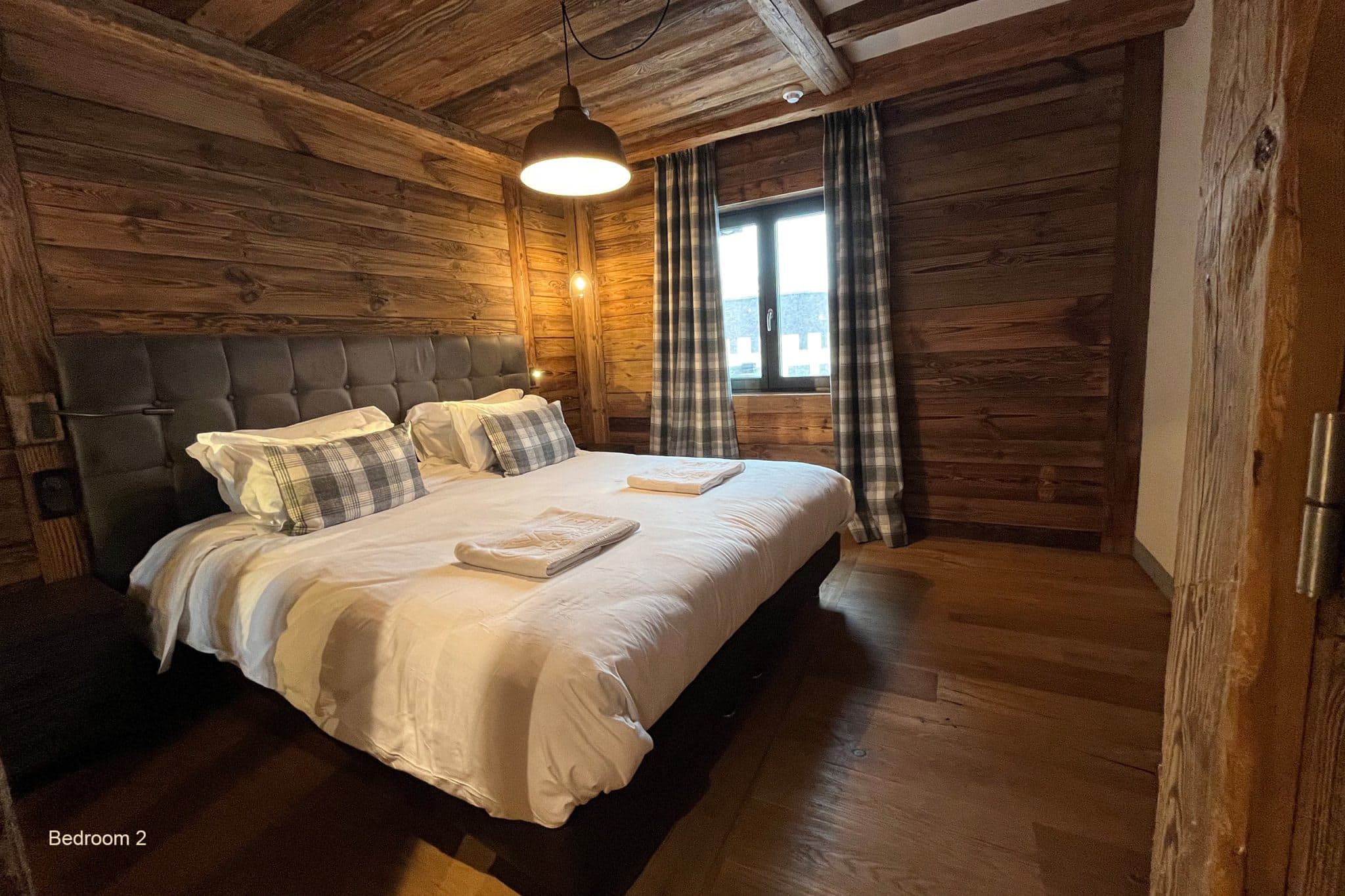 Bedroom 2 with king bed and reclaimed wood walls