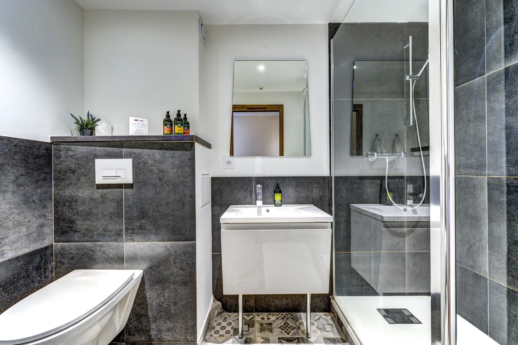 Bathroom with walk-in rainfall shower and wall-mounted vanity
