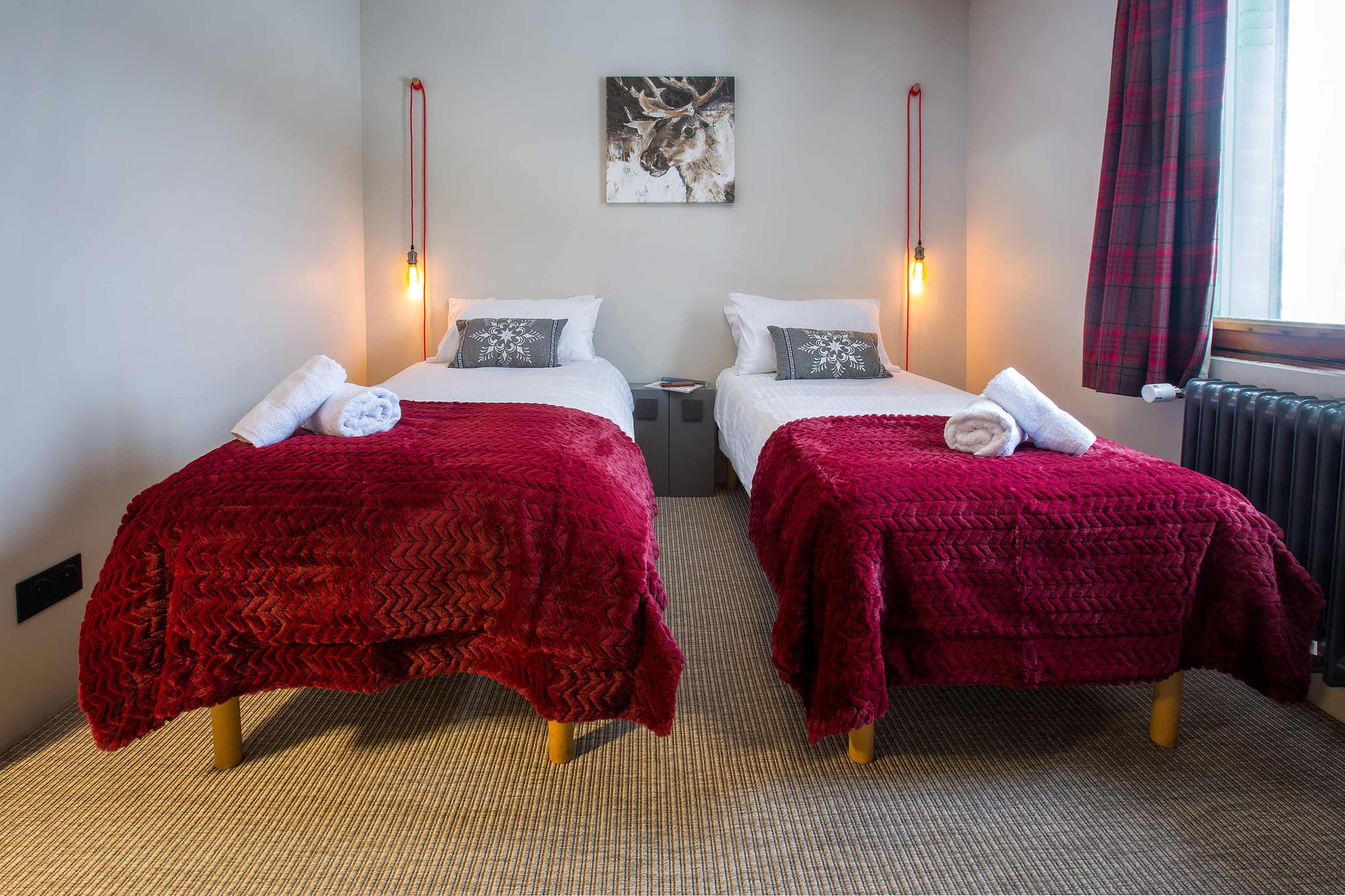Guest bedroom with two twin beds and individual bedside pendant lighting