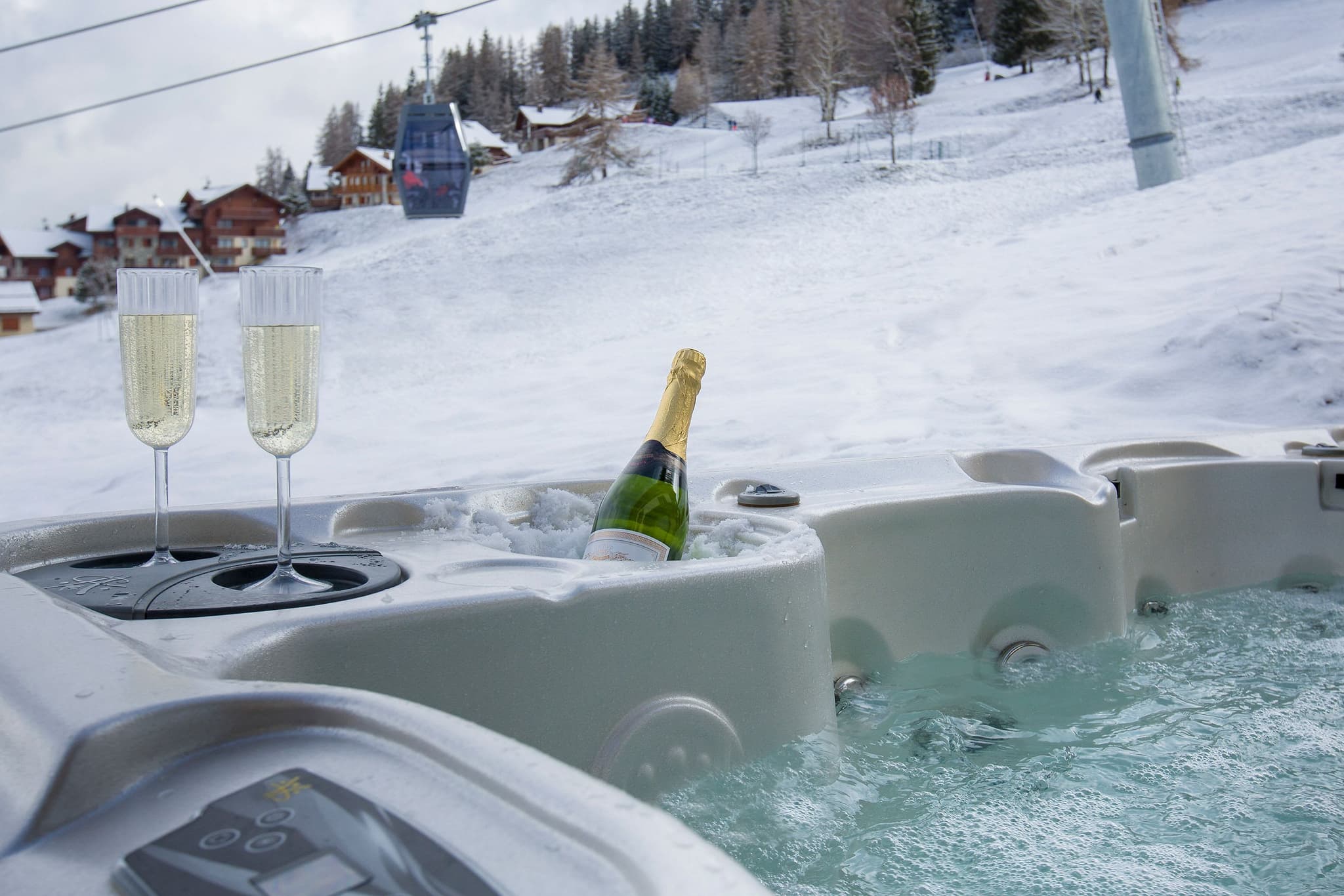 Outdoor hot tub with ski-in/ski-out access and gondola views